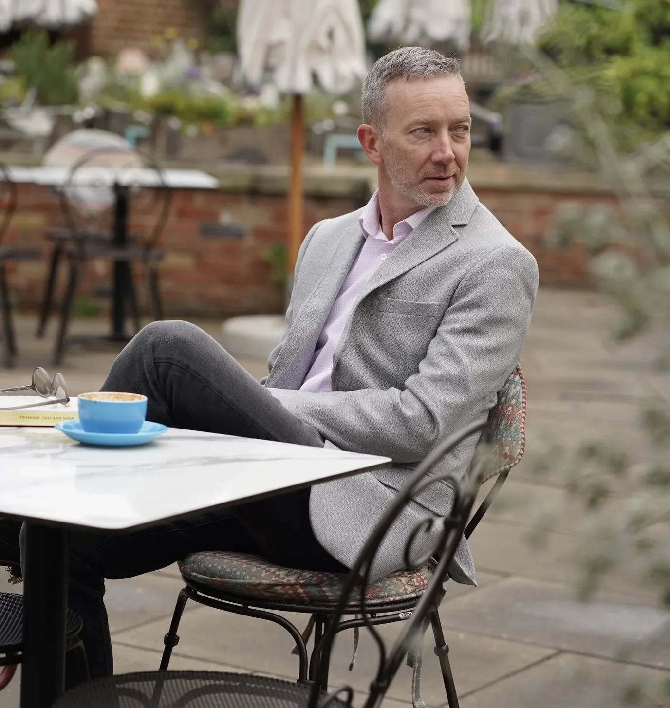A dating profile photo of a man in a cafe