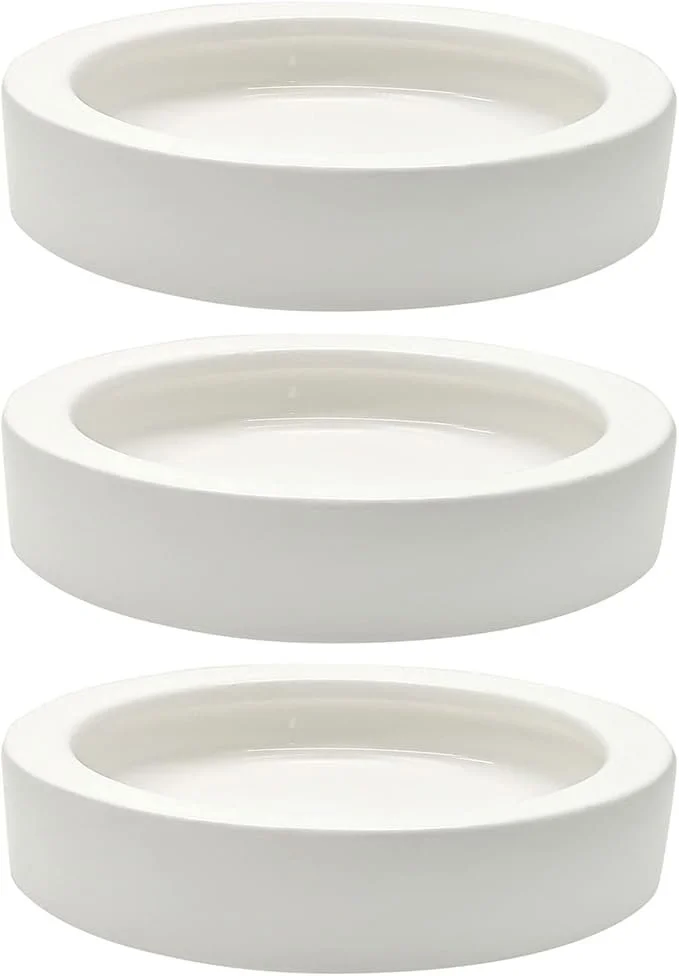 Three white oval-shaped ceramic escape-proof feeding dishes stacked vertically.