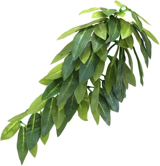 A bunch of green, glossy leaves from an artificial plant for a reptile terrarium, arranged with some overlapping and hanging downward.