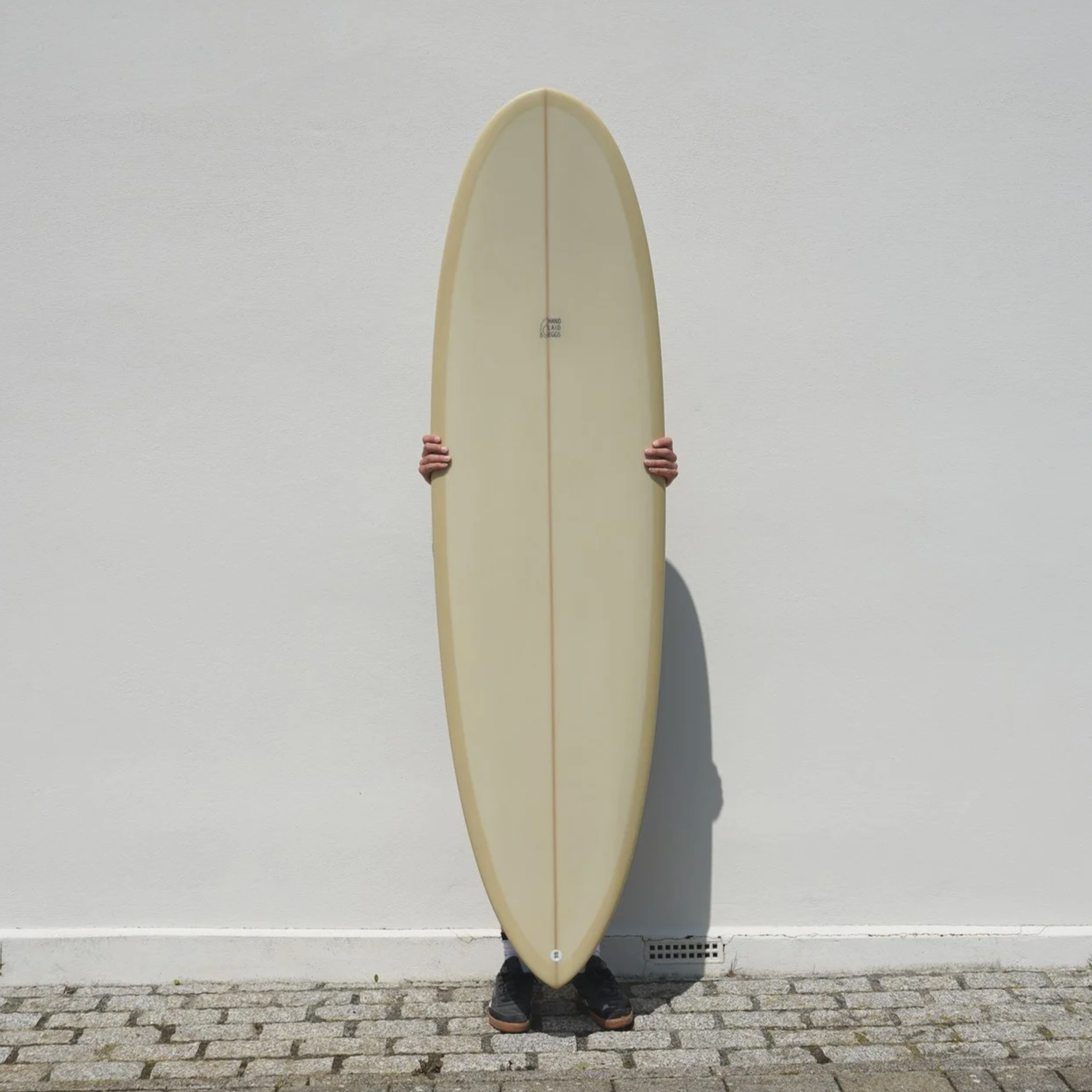 Round nose mid length surfboard with pin tail
