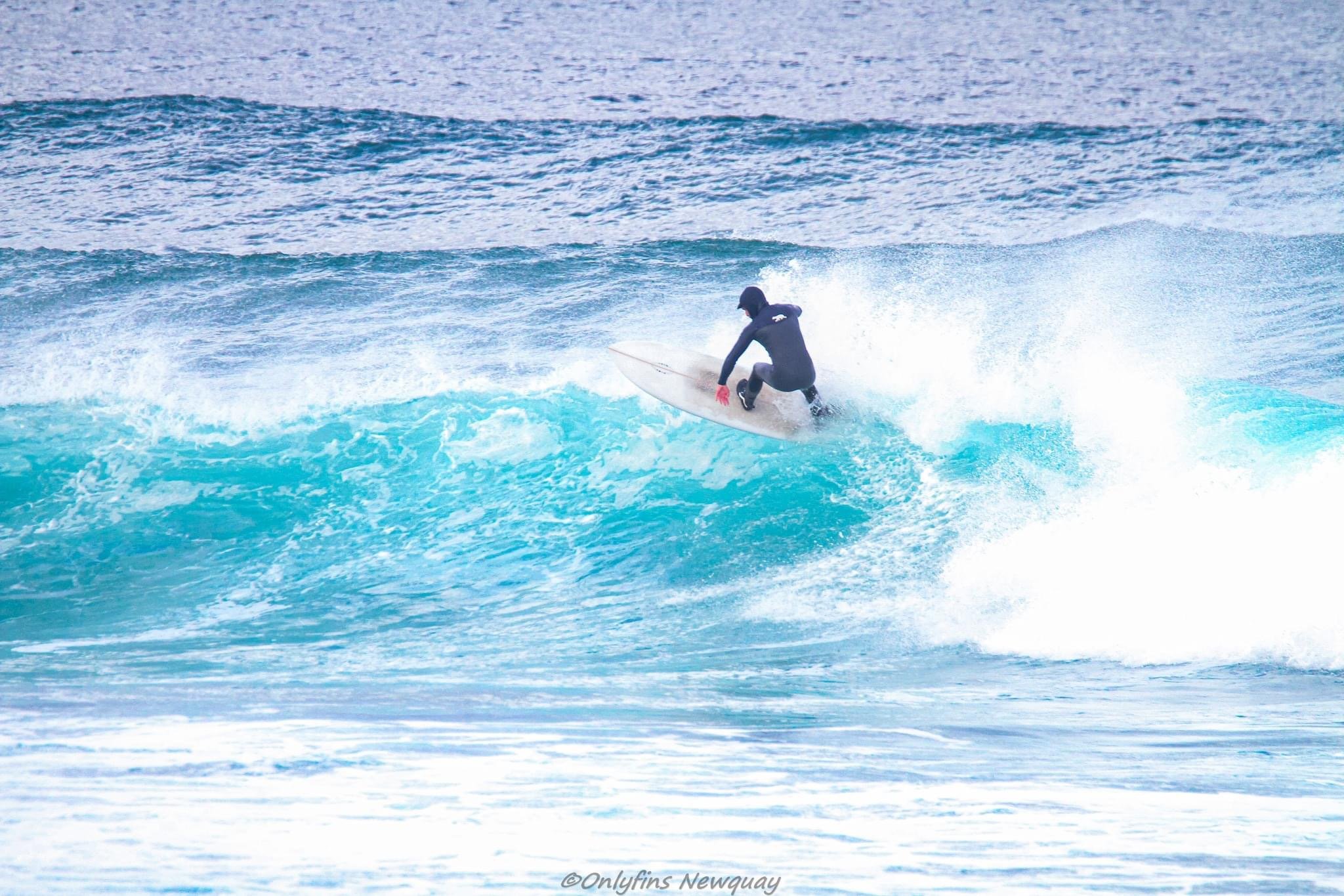 surfing a mid length surfboard in Cornwall