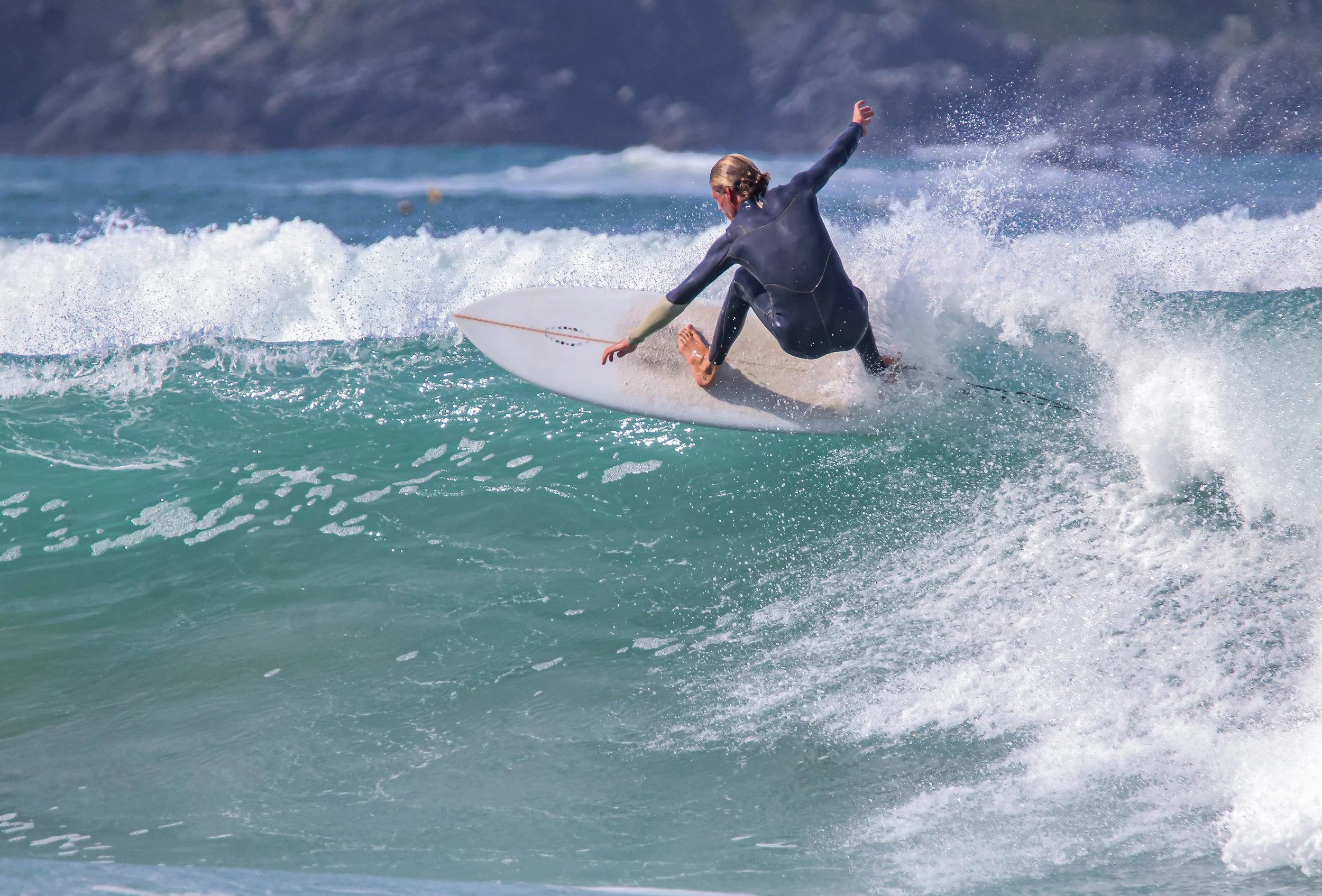 Surfer at Tolcarne, Newquay on a mid length surfboard