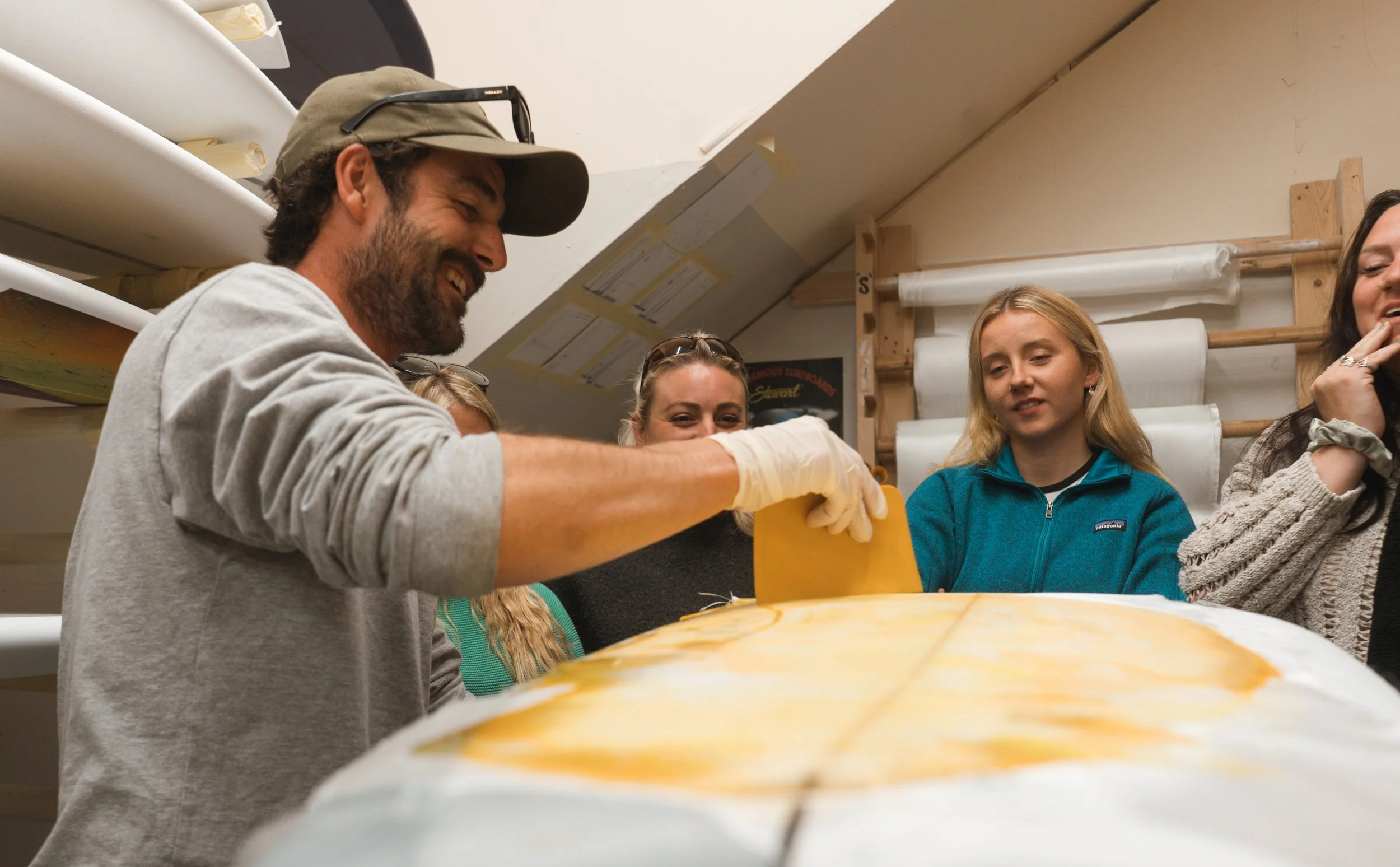 Surfboard shaper shows how colour is added to fibreglass surfboards