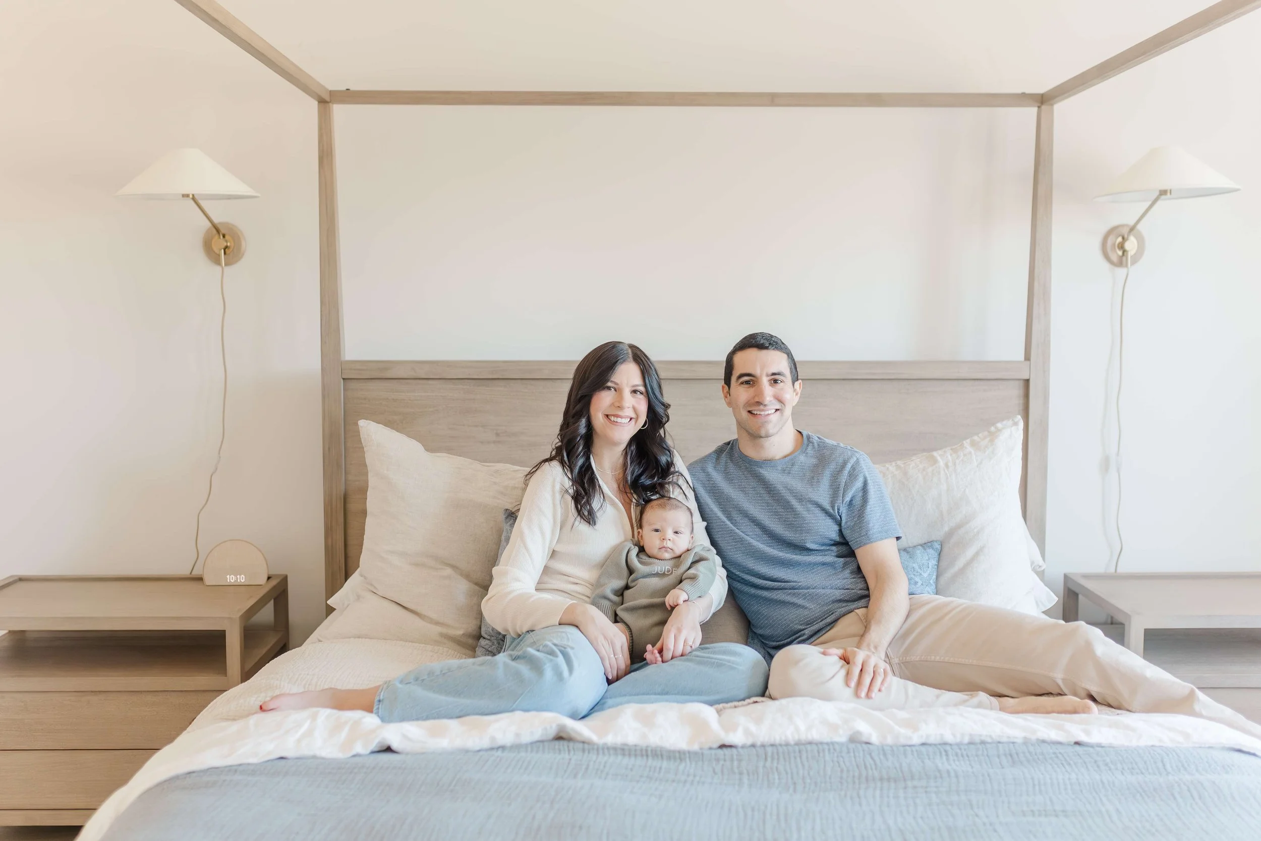 New parents sitting on canopy bed with newborn baby boy, lifestyle newborn session Piedmont SC