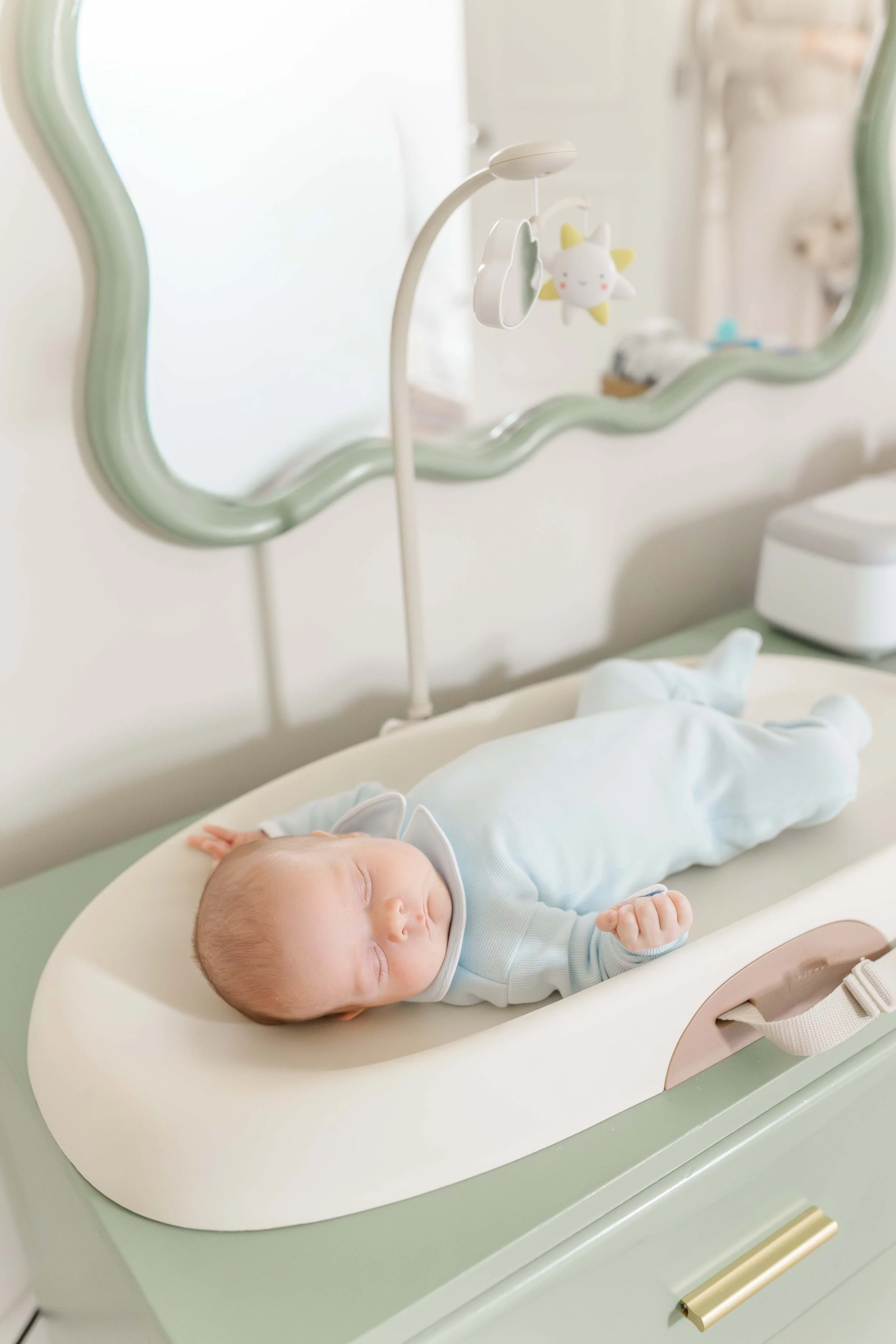 Close-up of newborn baby Thomas on changing table during in-home lifestyle newborn photography in Laurens, SC | Erin Turner Photography
