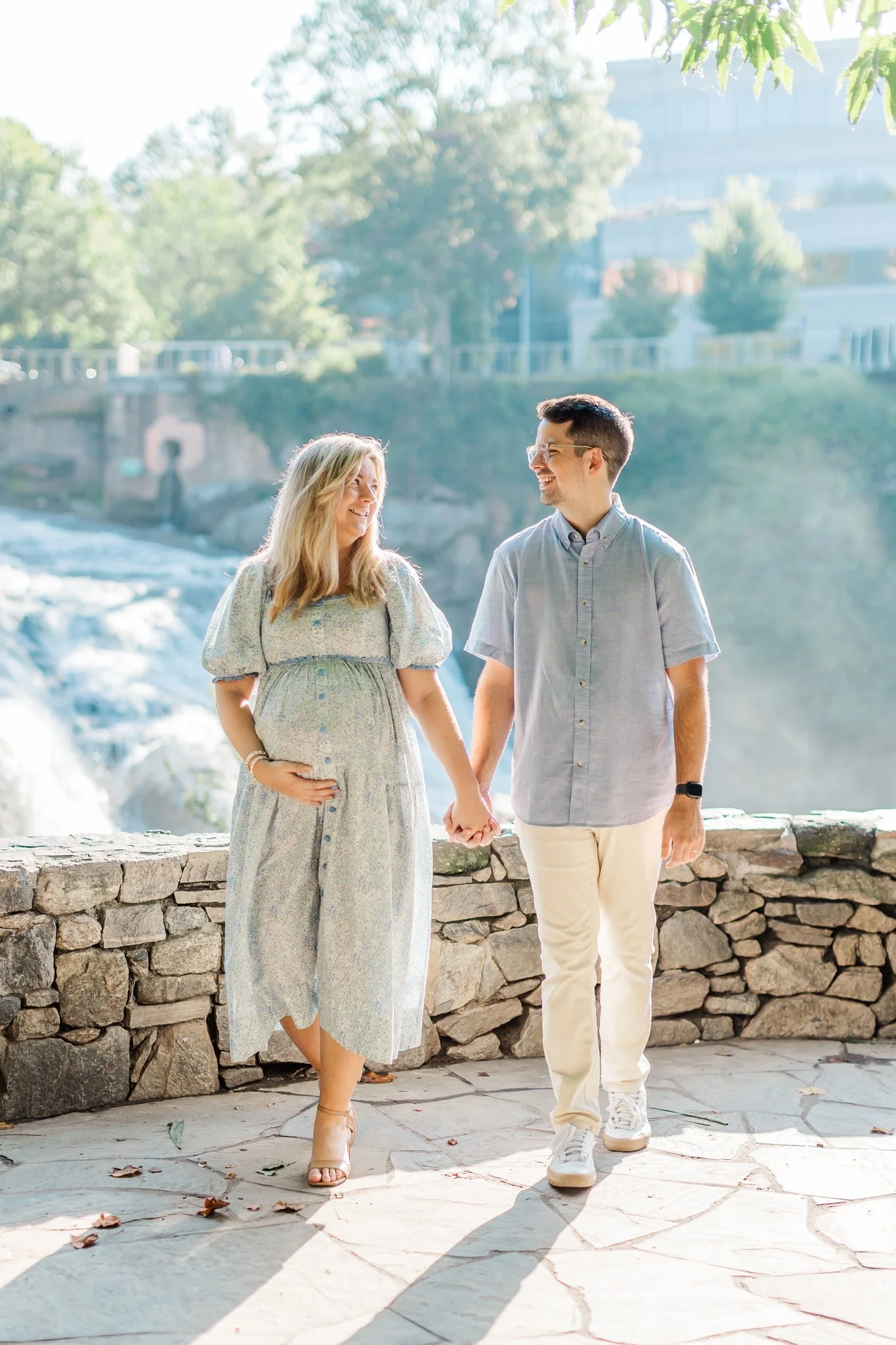 Expecting mom in blue dress at falls park in greenville south carolina for maternity session