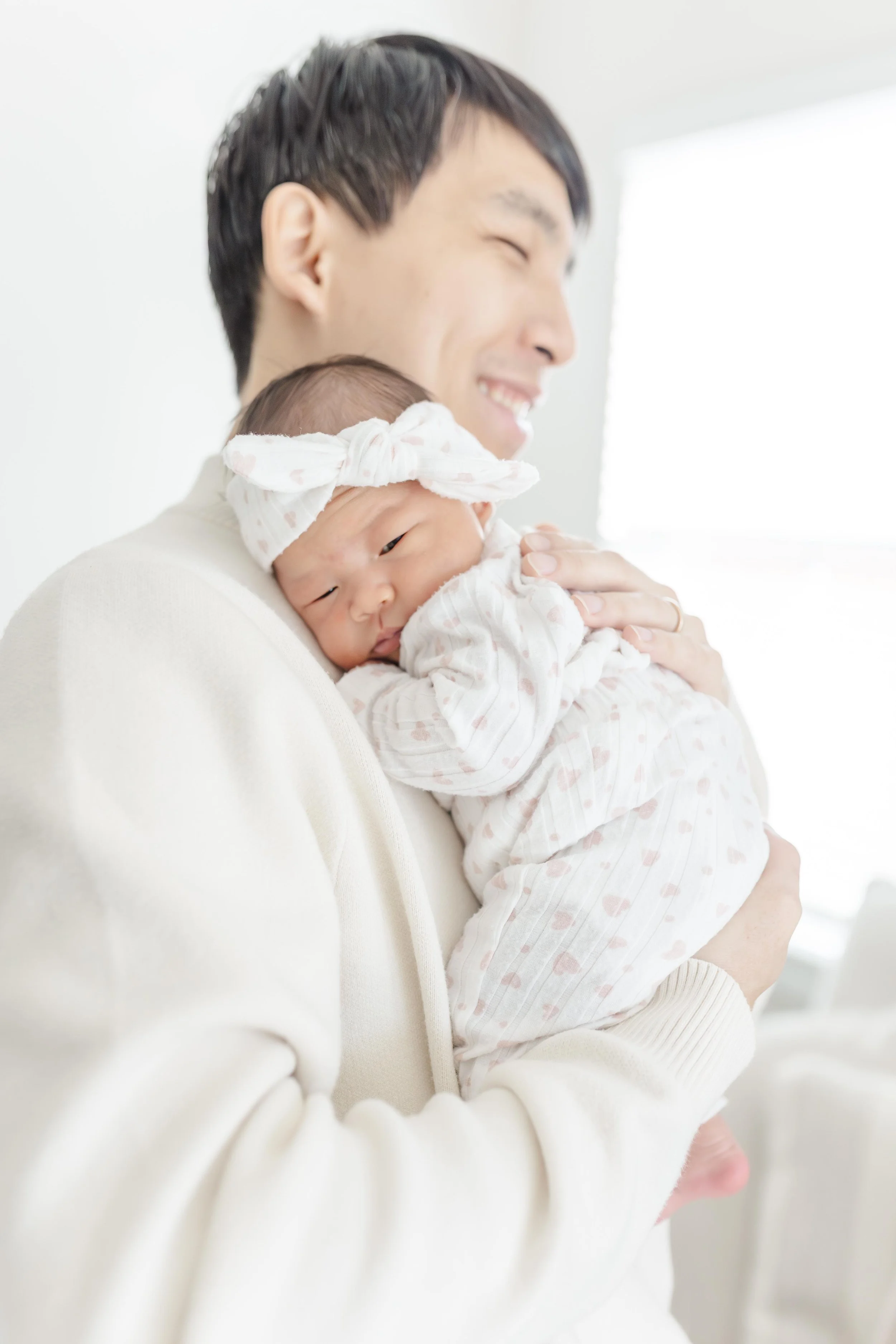 Dad holding his newborn baby girl close, touching noses in a tender moment — Greenville South Carolina newborn photography