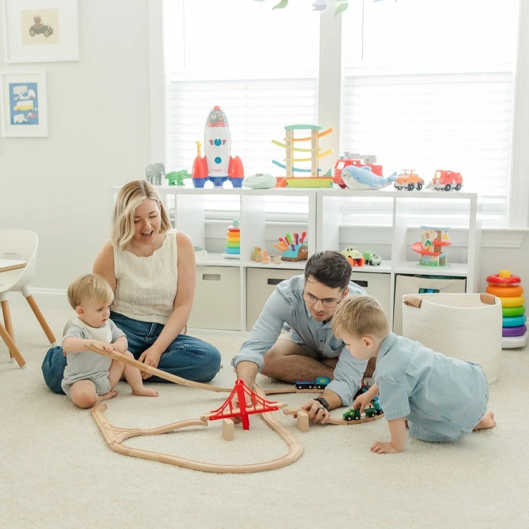 No park. No golden hour scramble. No "okay everyone look at the camera."

Just your family, your home, and a Saturday morning that actually looks like your life.

Train tracks still on the floor. The book you read every single night. Dad do