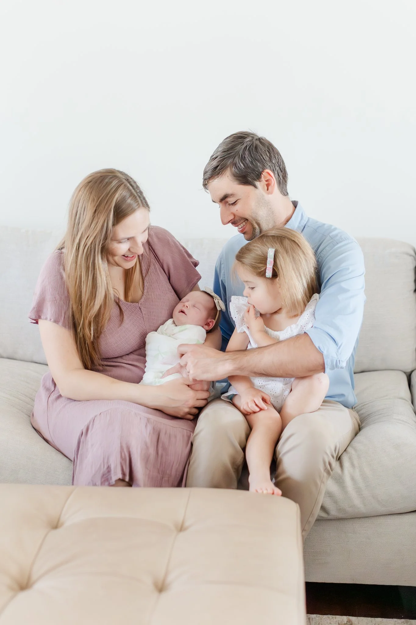 Full family portrait on living room couch, Upstate SC lifestyle newborn photography
