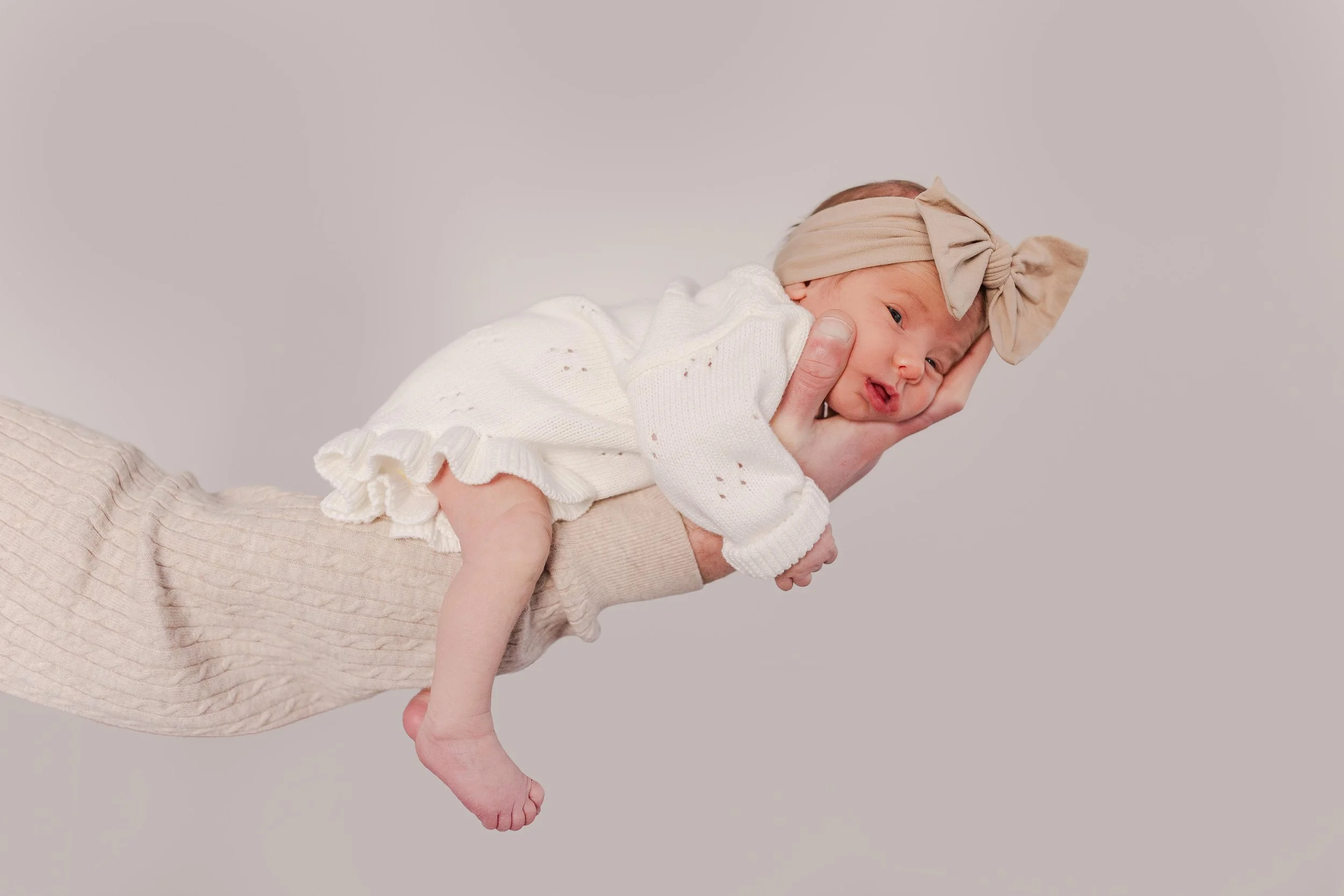 dad holding newborn baby girl in nursery, lifestyle newborn photographer Easley SC
