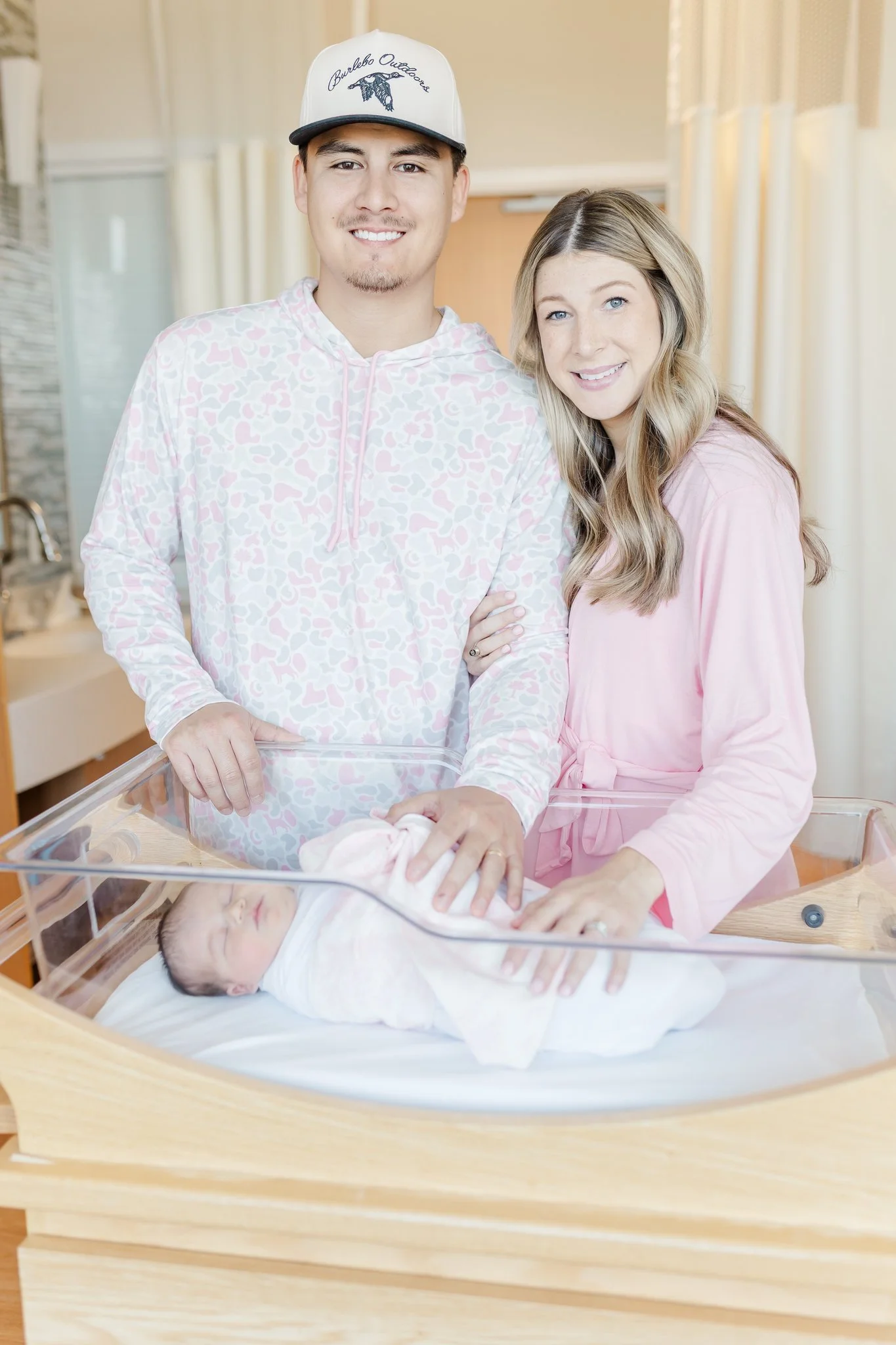 mom and dad smiling at hospital at fresh 48 newborn session