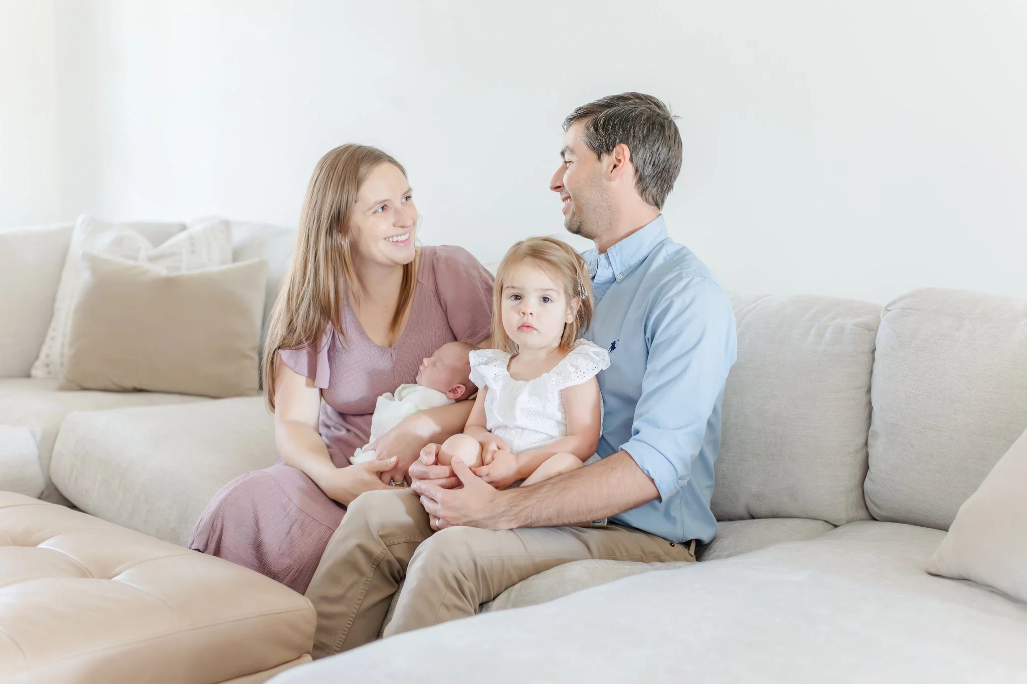 Full family portrait on living room couch, Upstate SC lifestyle newborn photography