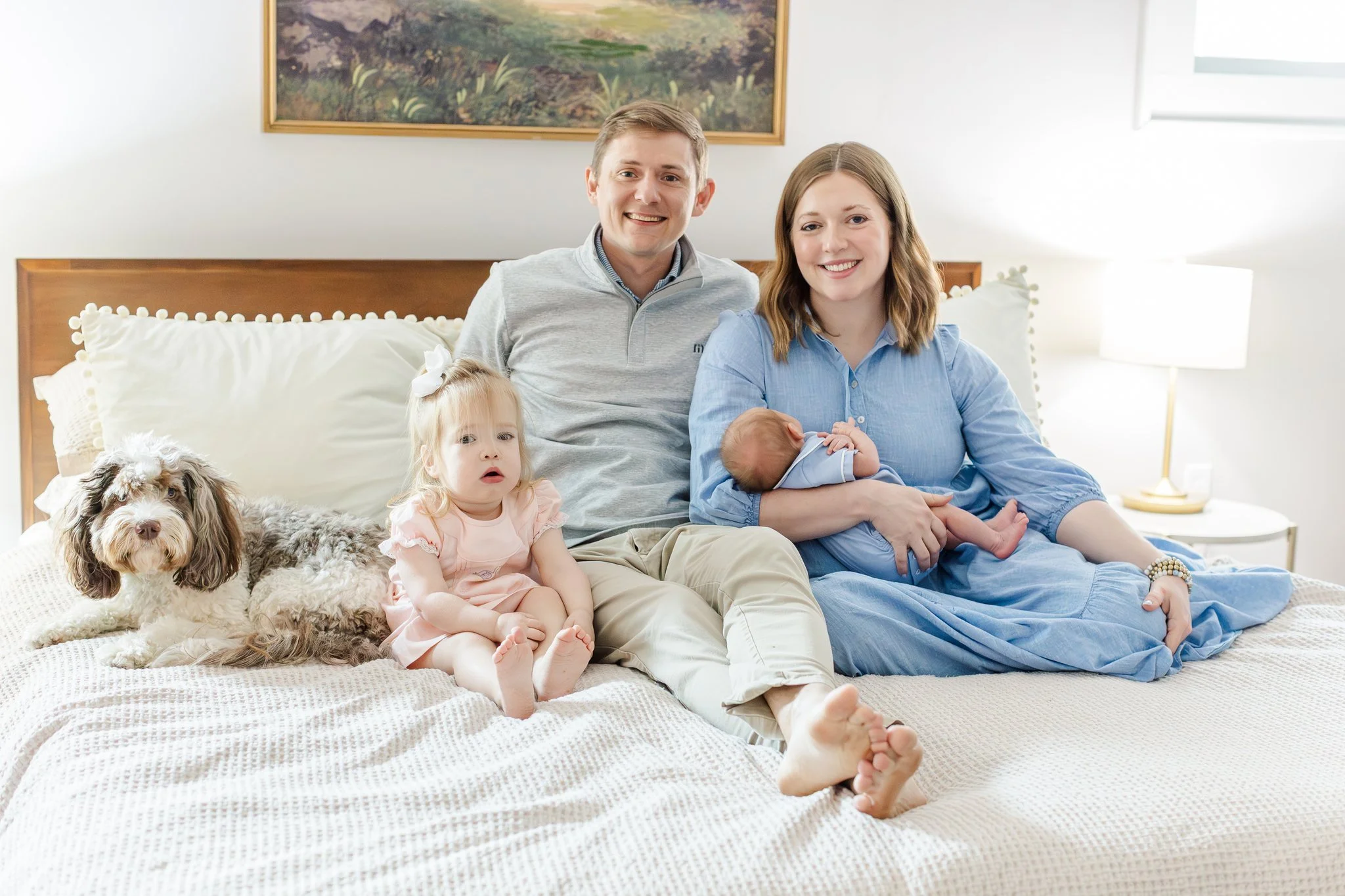 family on bed at greenville at home newborn session