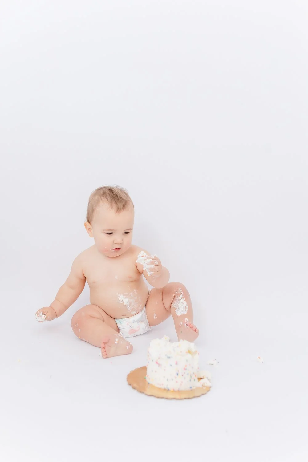 one year cake smash in a studio milestone session in greenville south carolina