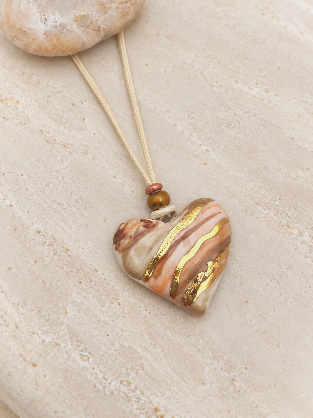 Marbled Gold Heart Pendant on Stone.png