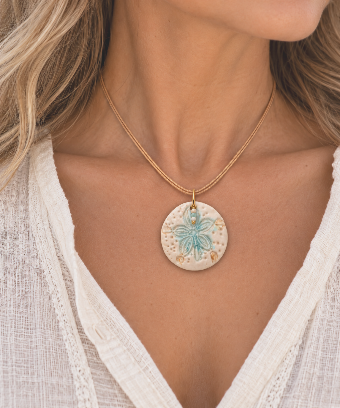 Boho Sand-Dollar Pendant on Linen Blouse.png