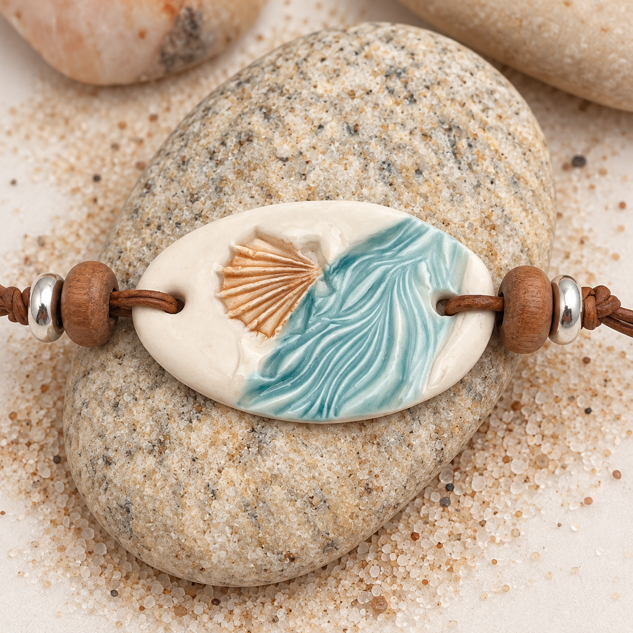 Coastal Wave Ceramic Pendant on Pebbles.png