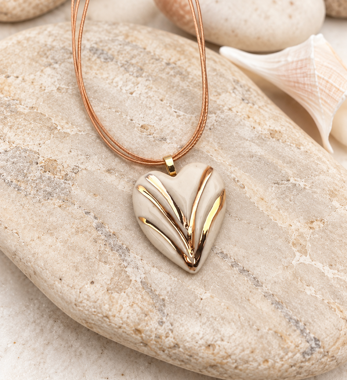 Golden Heart Pendant on Coastal Stone.png
