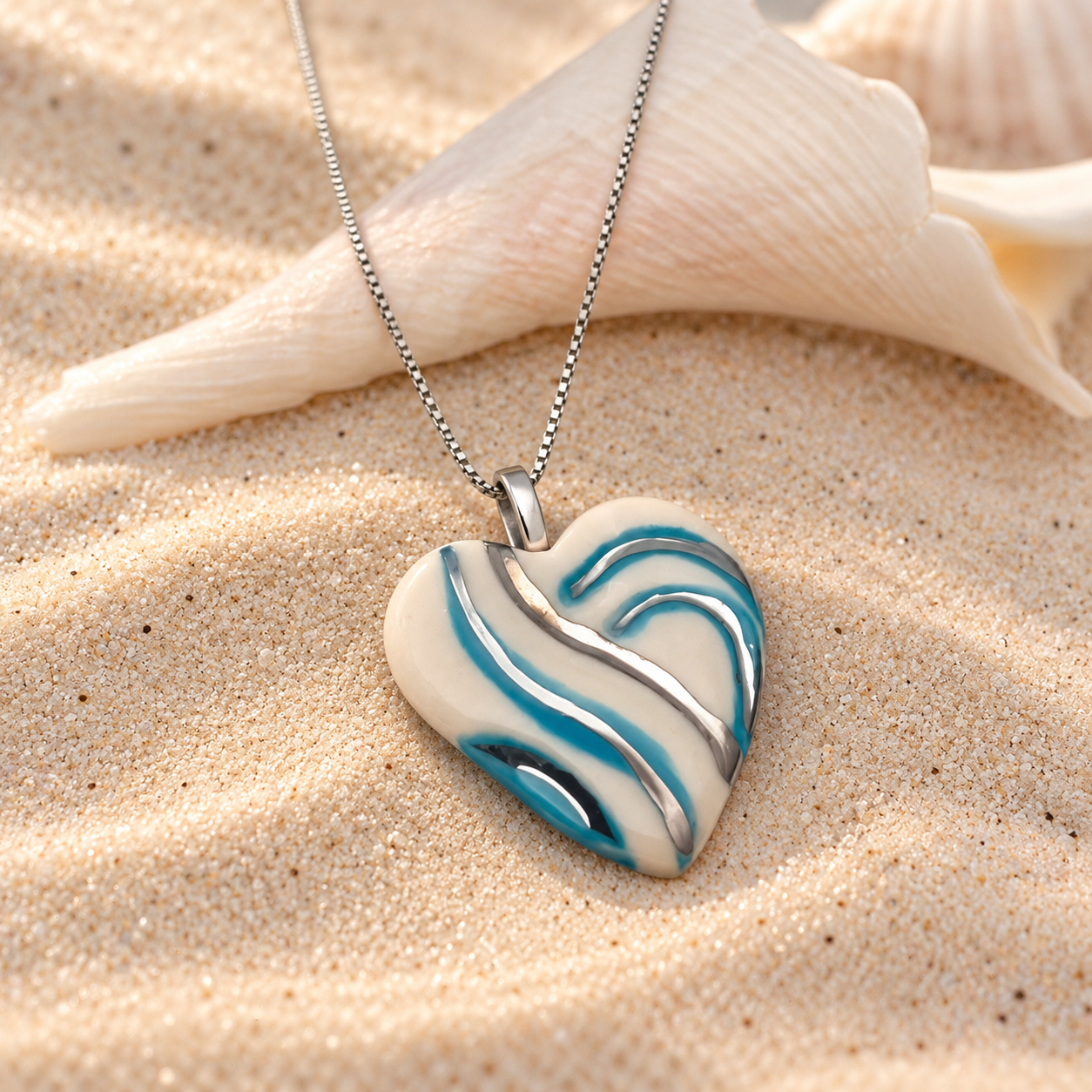 Turquoise Wave Heart Pendant on Sand.png