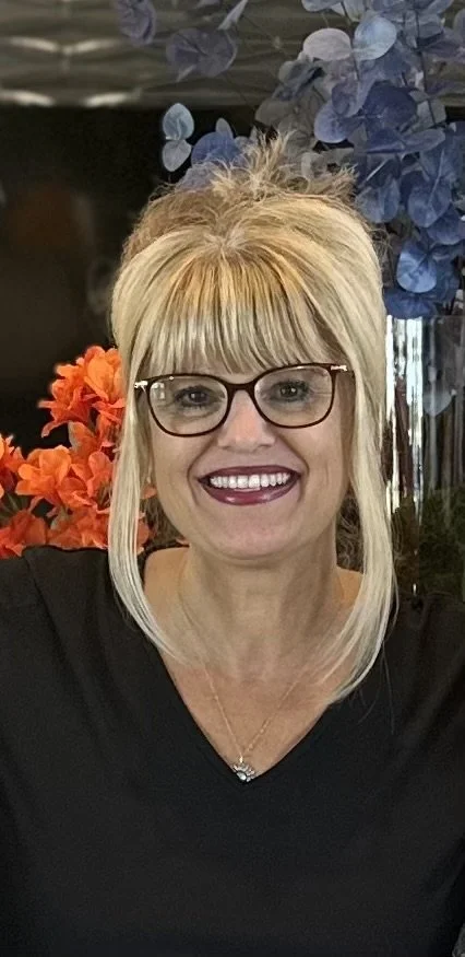 image of woman in a black jacket and glasses