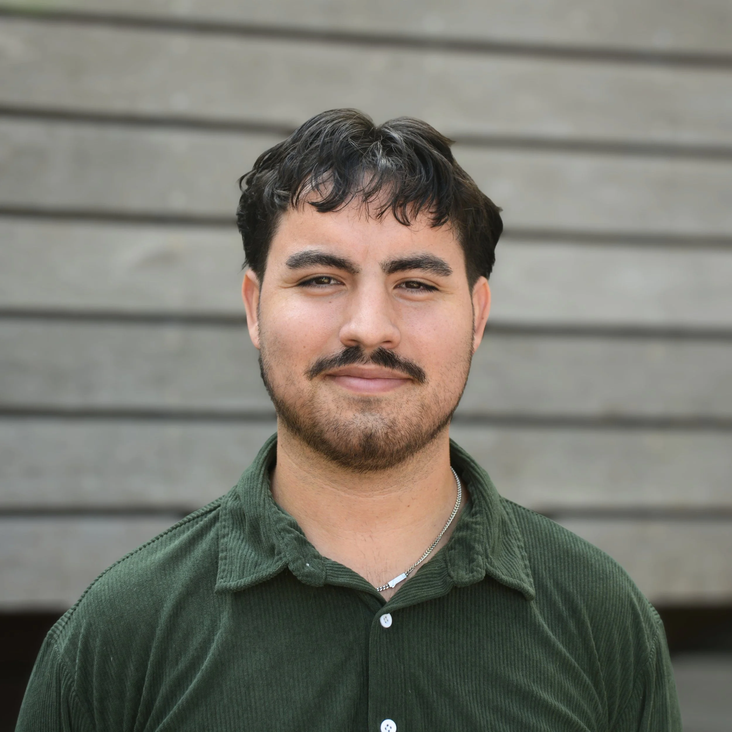 Jake Land, Designer at SWT Design, Smiling outdoors.