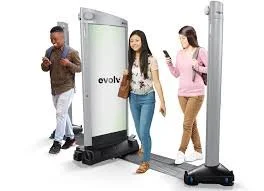 Three people using a telepresence robot in a hallway.