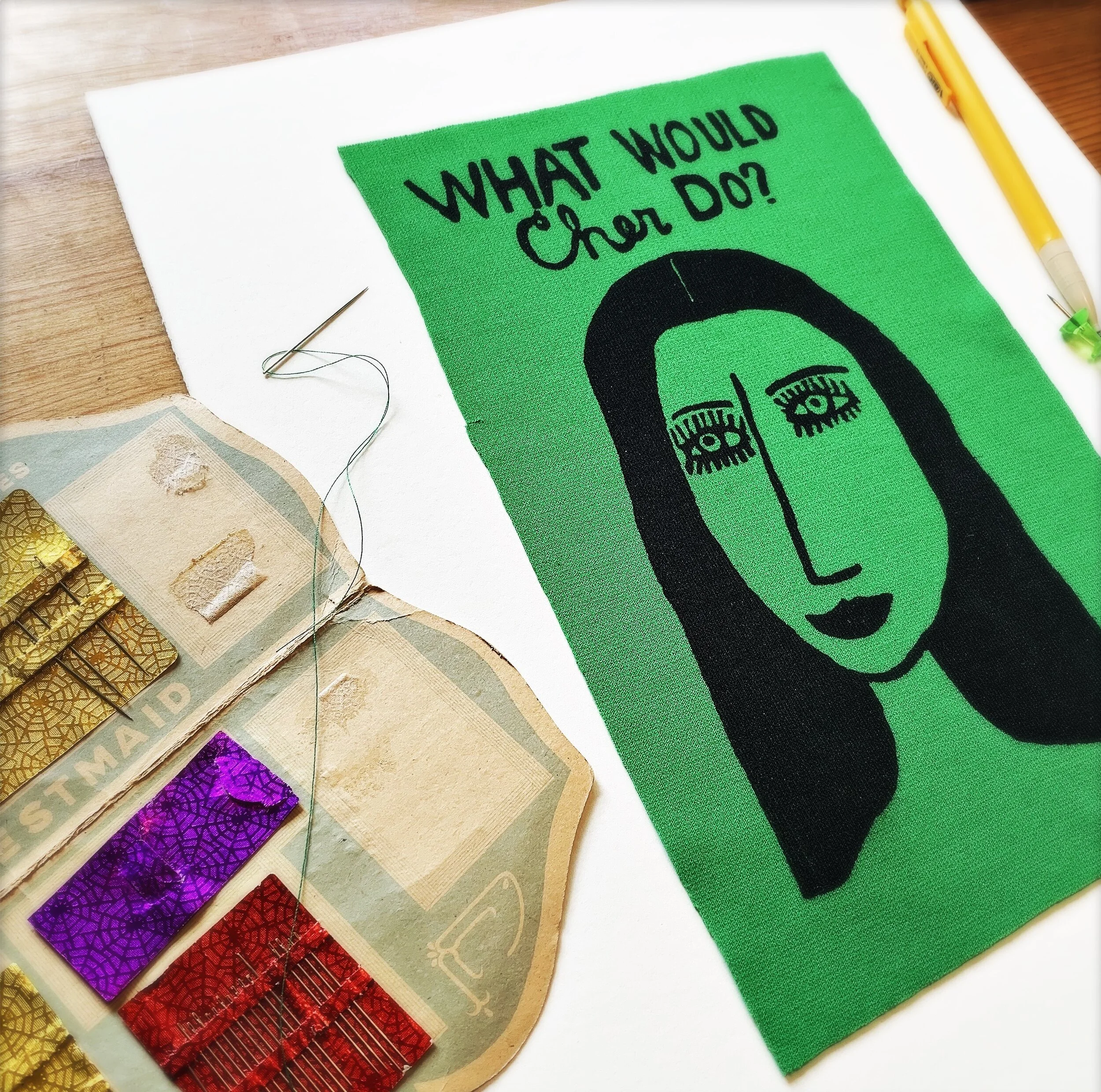 Fabric art with green background and illustration of Cher by Shari Elf.