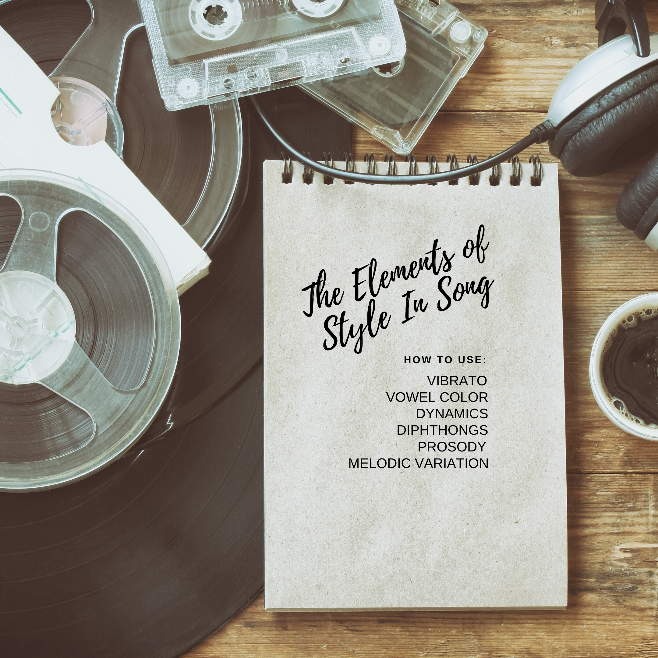 Table top with reel to reel and cassette tapes, headphones, a cup of coffee, and a notepad with The Elements of Style In Song written on it.