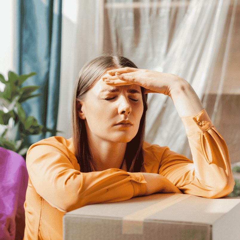 Woman resting with hand on forehead