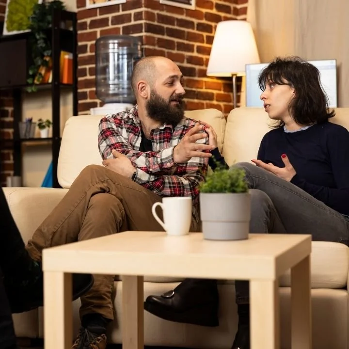 Couple communicating openly during a guided relationship counseling session.