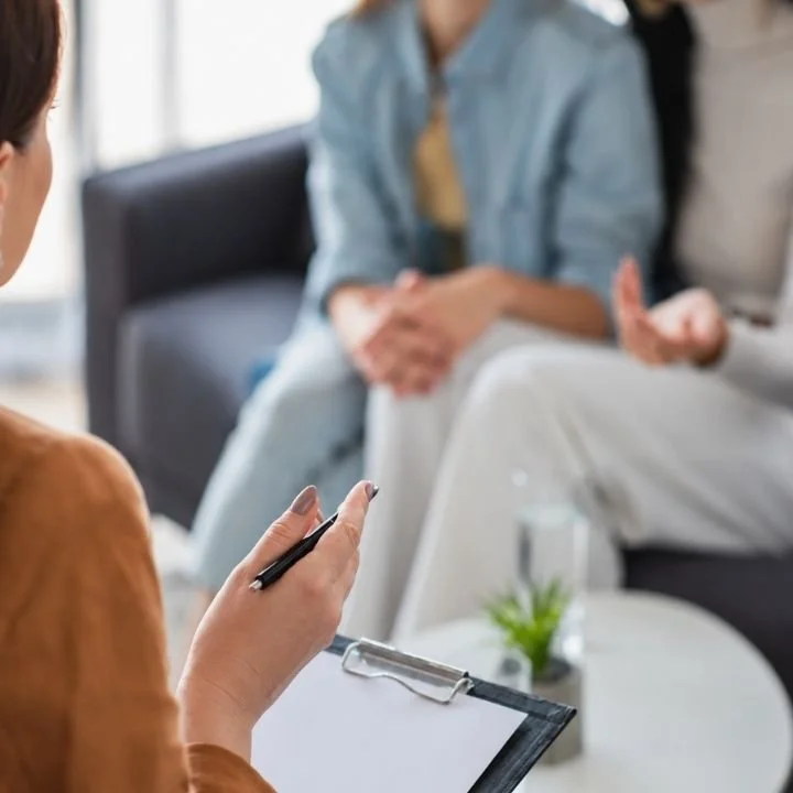 Therapist guiding a couple through communication during a relationship counseling session.
