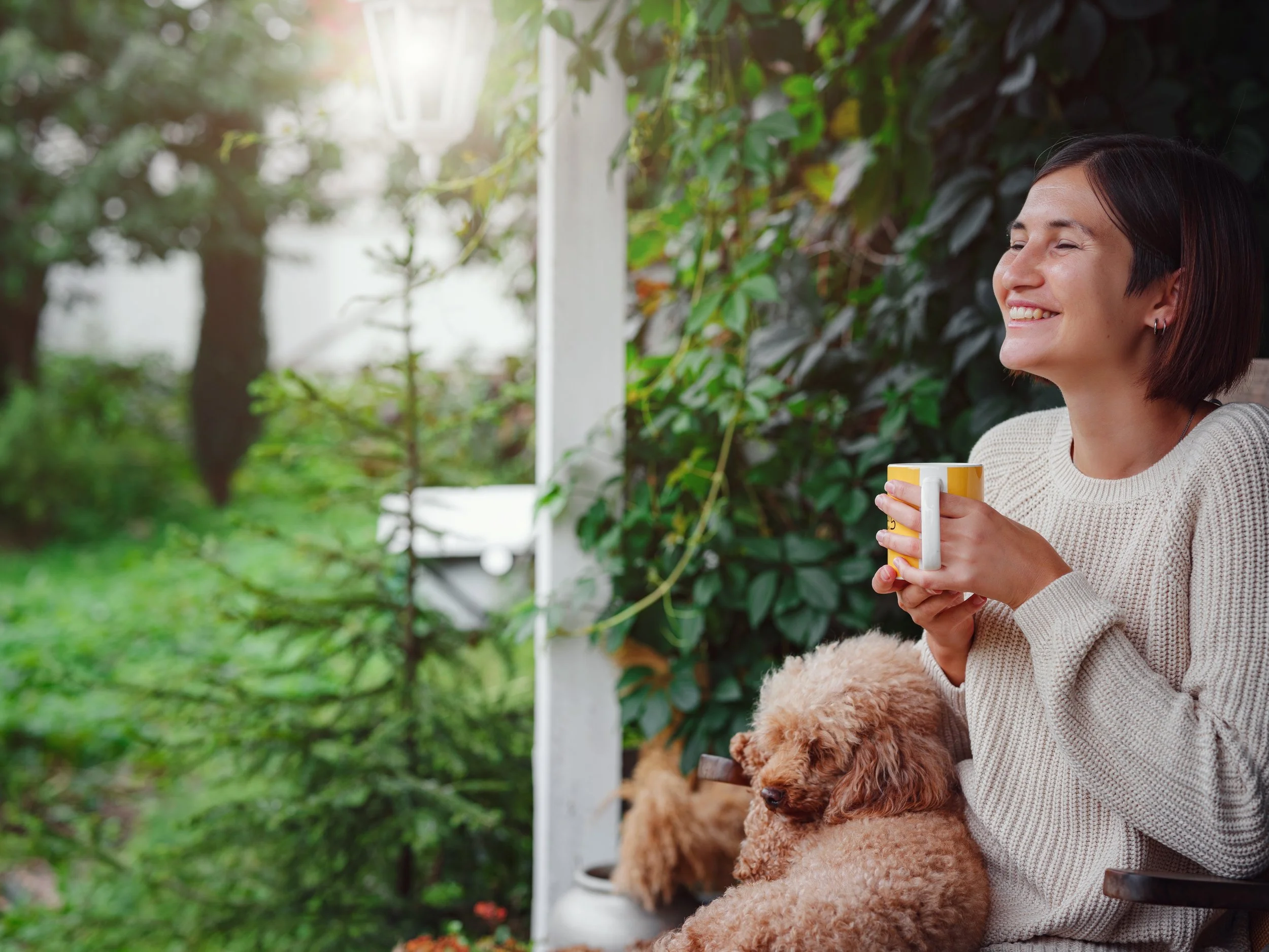 Woman enjoying a peaceful morning with her dog after making meaningful changes through individual therapy.