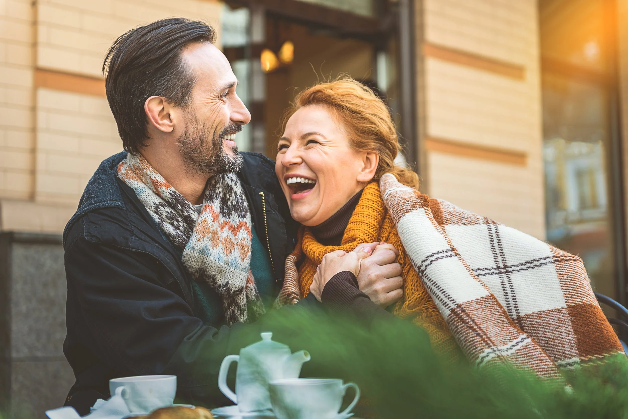 Couples workshop participants cozy together in a café, representing Sacred Healing Counseling’s relationship-building intensives and therapy retreats serving Florida and South Carolina