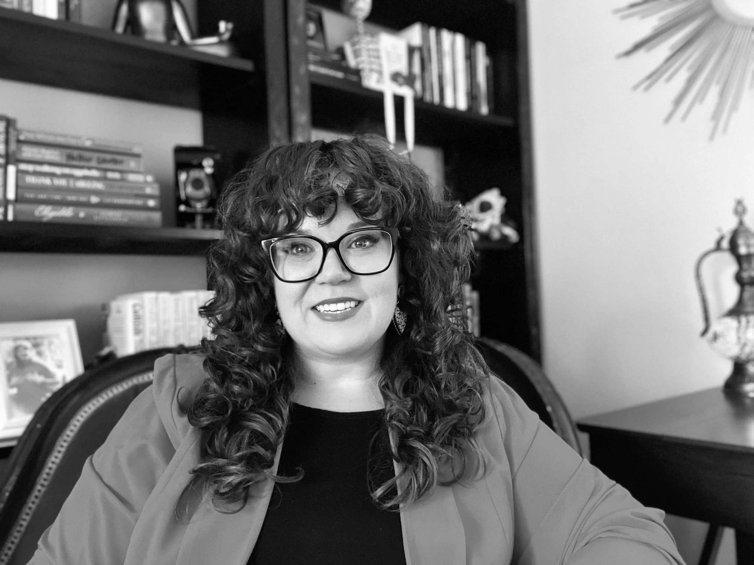 Headshot of Mariah Plociniak, licensed therapist at Sacred Healing Counseling, smiling in her office and ready to help clients overcome burnout and reconnect with themselves.