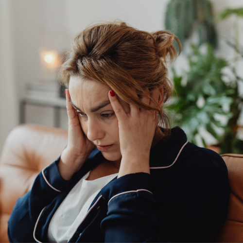 Woman holding her head while feeling overwhelmed