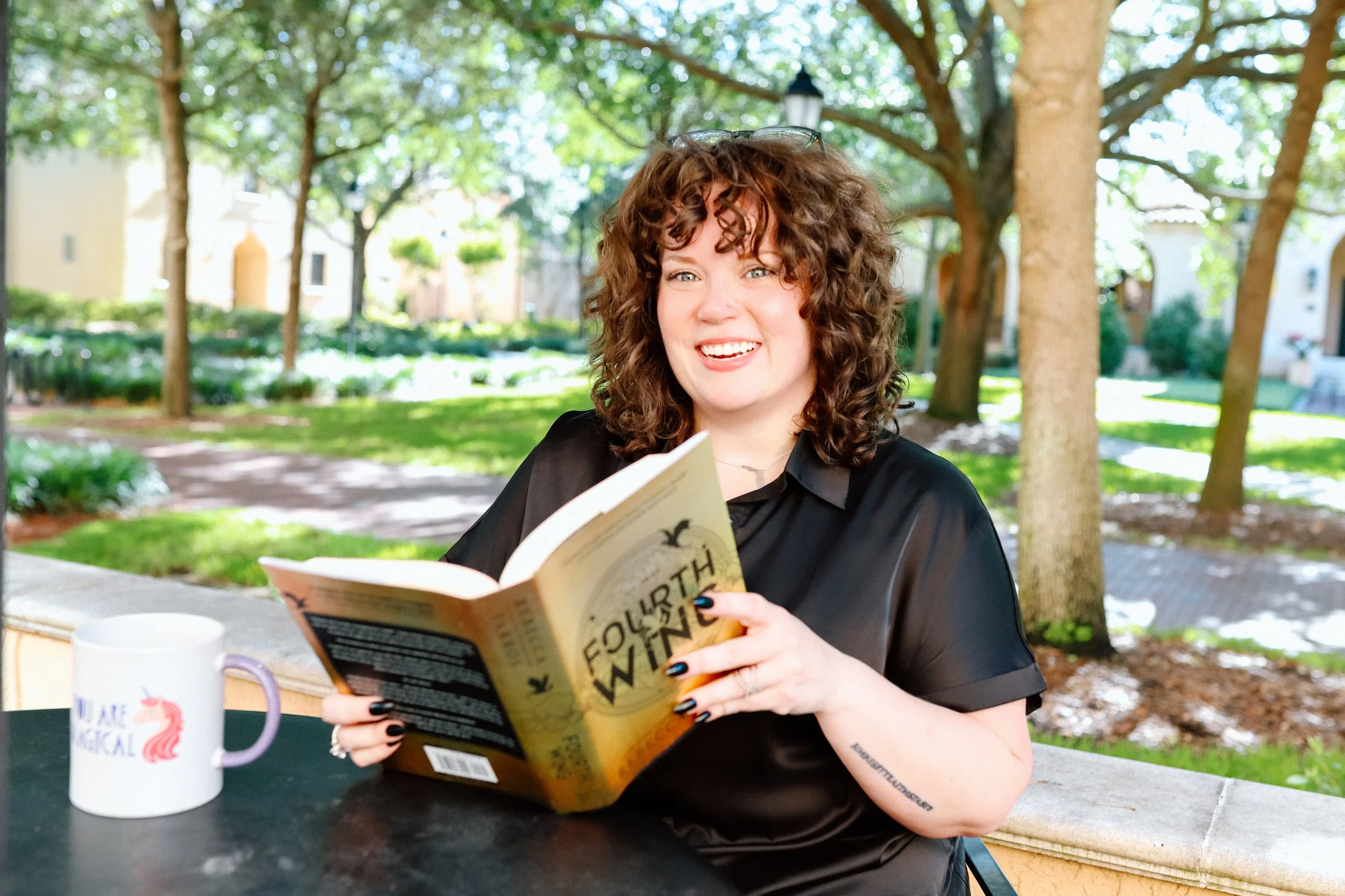 Dr. Mariah Plociniak, LMFT, reading outdoors and providing therapy for women in Orlando, Florida and online throughout Florida.