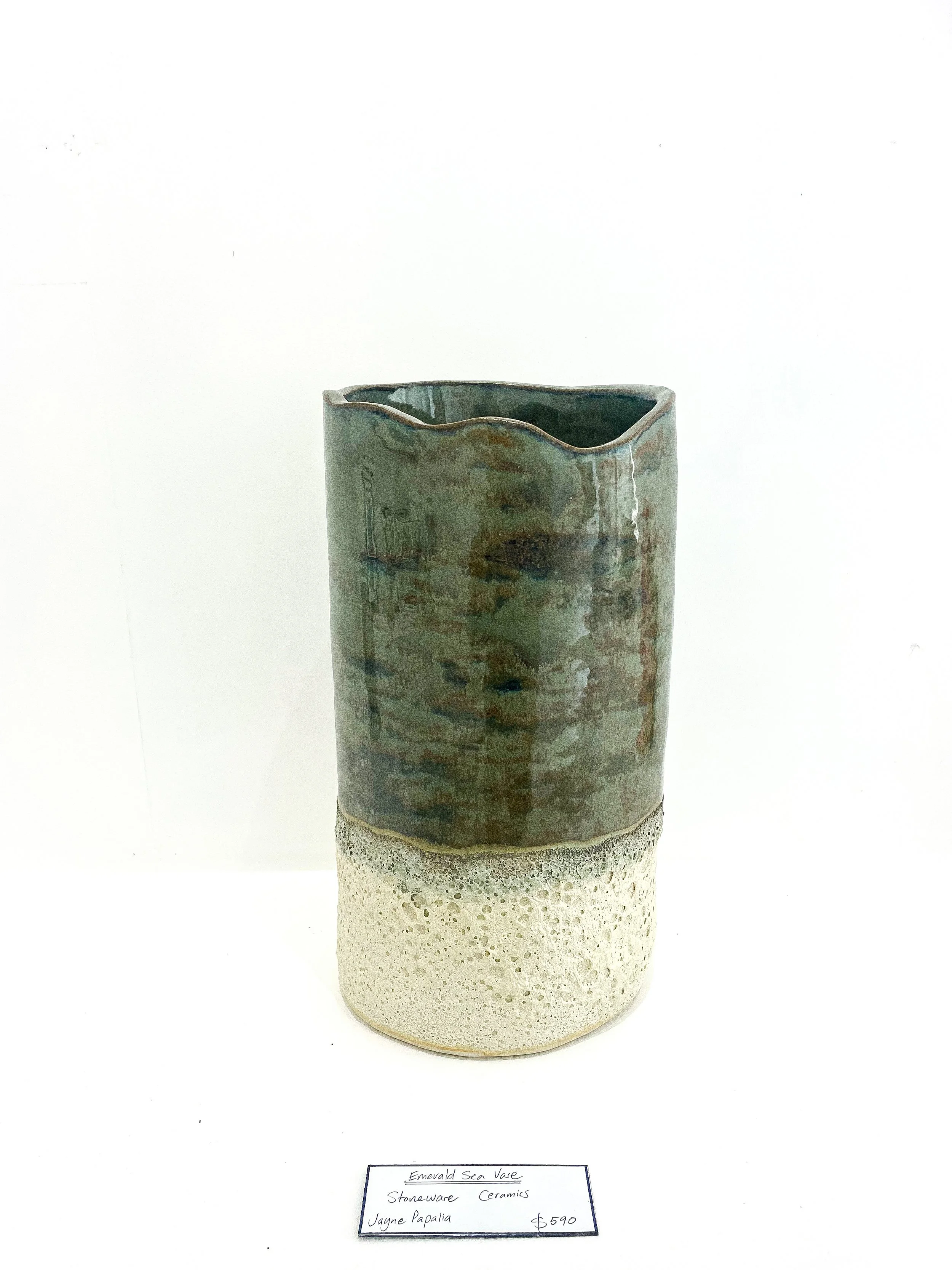 Ceramic vase with a textured white bottom and green glazed top, displayed against a plain white background with a handwritten price tag and description.