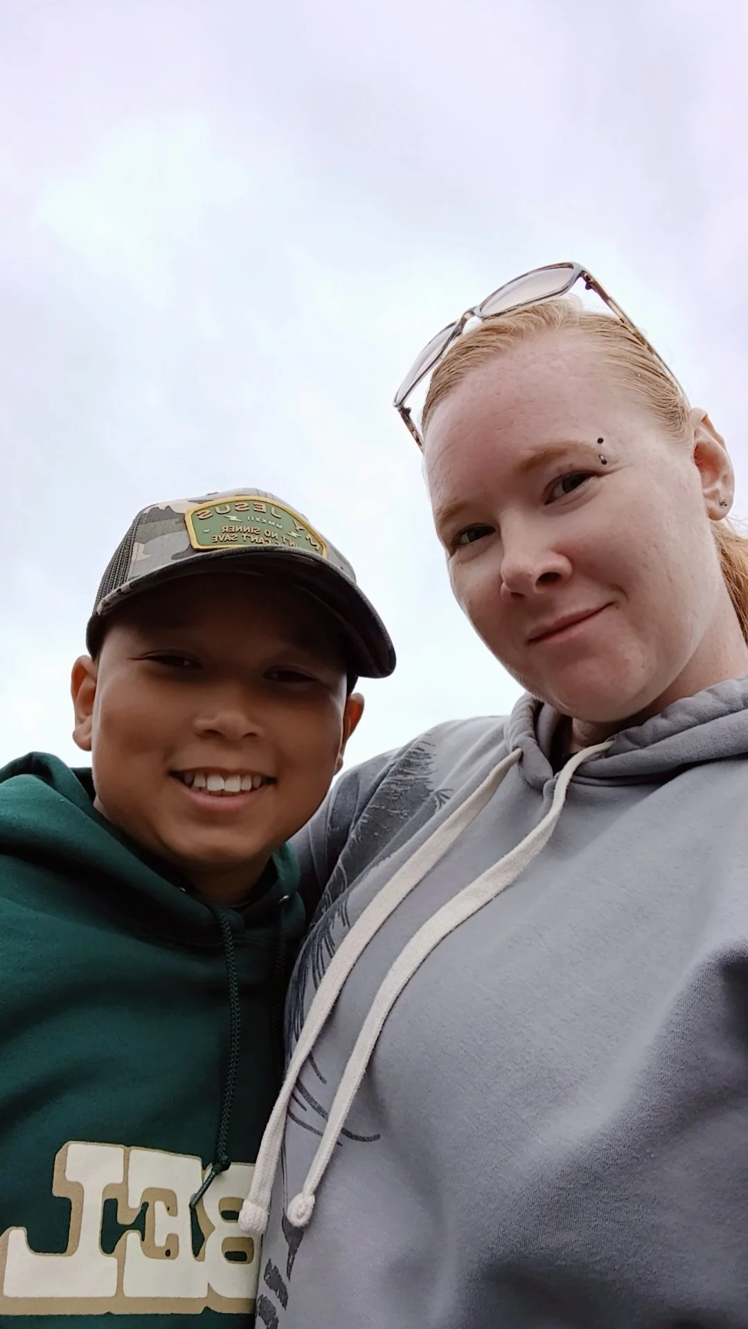 A mother and son embraced together smiling.