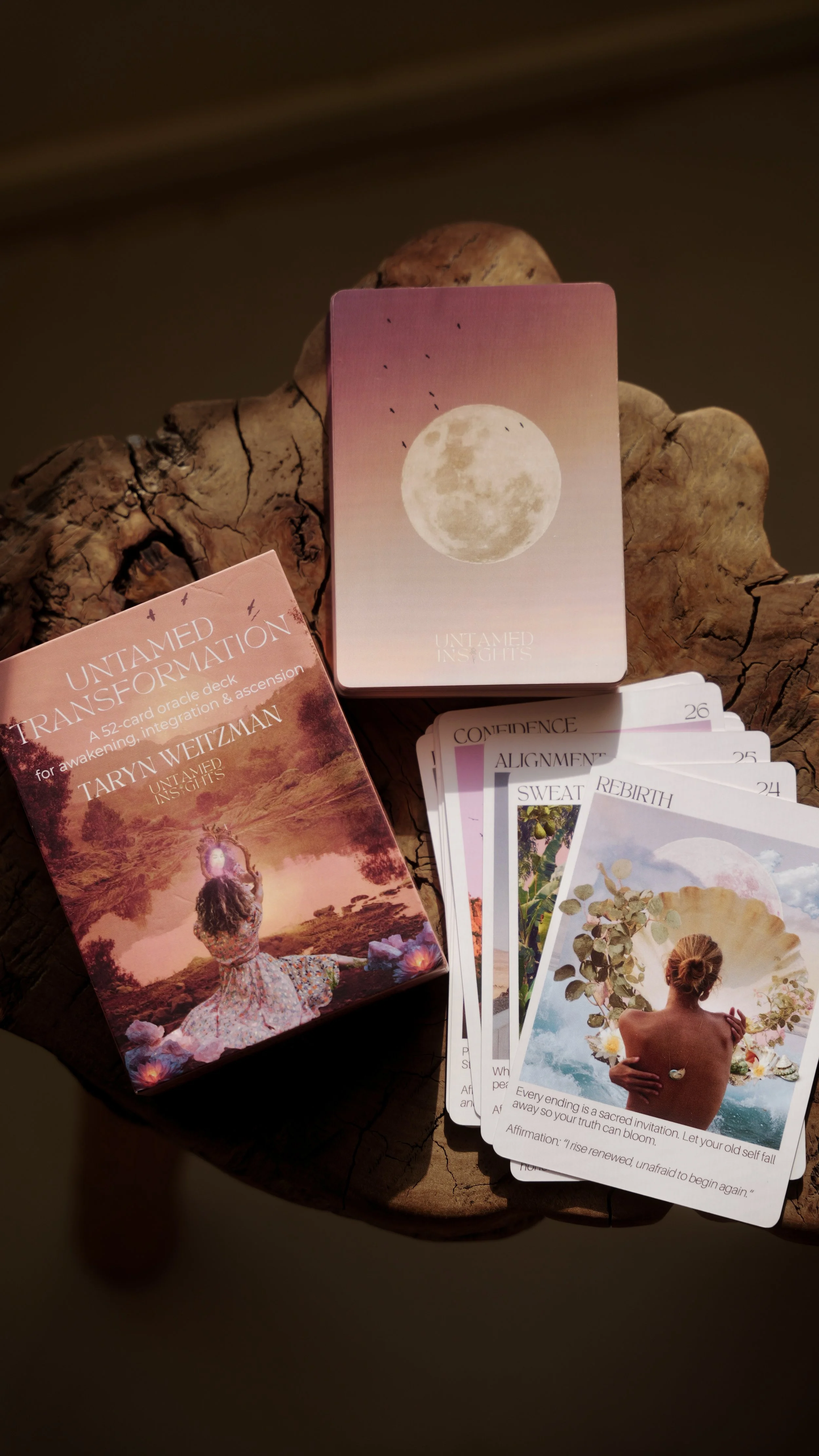 Untamed Transformation Oracle Deck box, back of the card with moon and birds and the rebirth card with image of back of woman