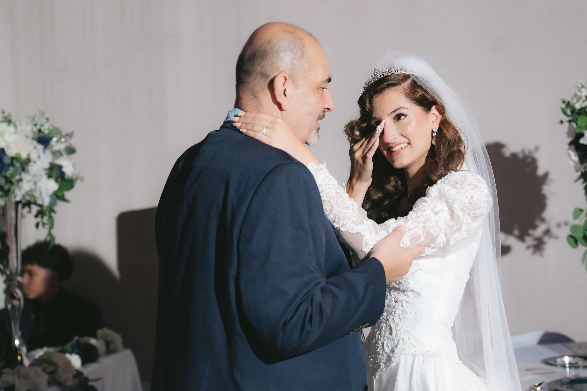 crying bride with her father