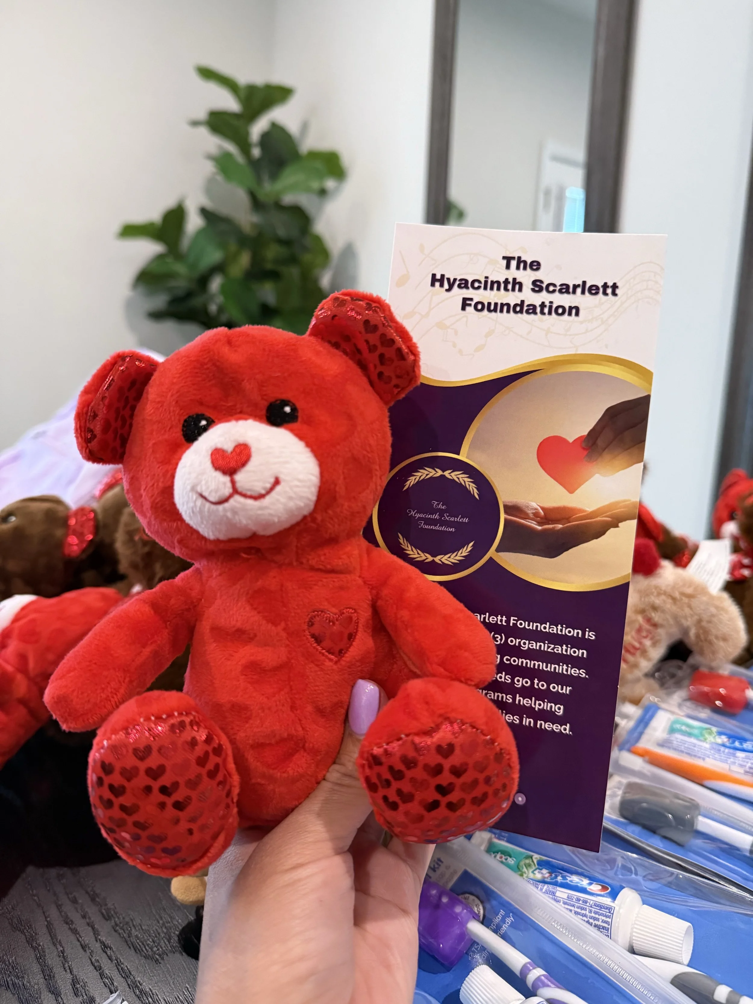 Purple and pink hyacinth flowers arranged in a heart shape on a pink background.