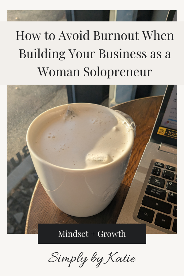 Blog header image for "How to Avoid Burnout as a Woman Solopreneur" featuring a white latte and a silver laptop on a wooden desk, by simply by katie.