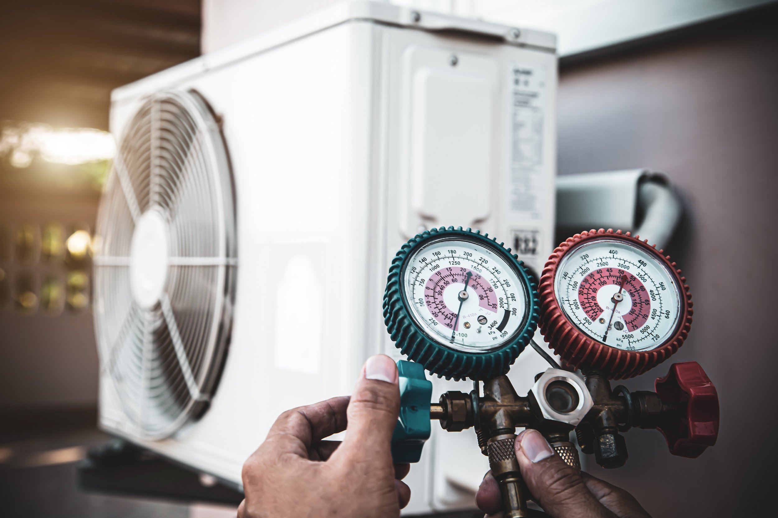 close-up-hand-technician-using-manifold-gauge-filling-air-conditioners.jpg