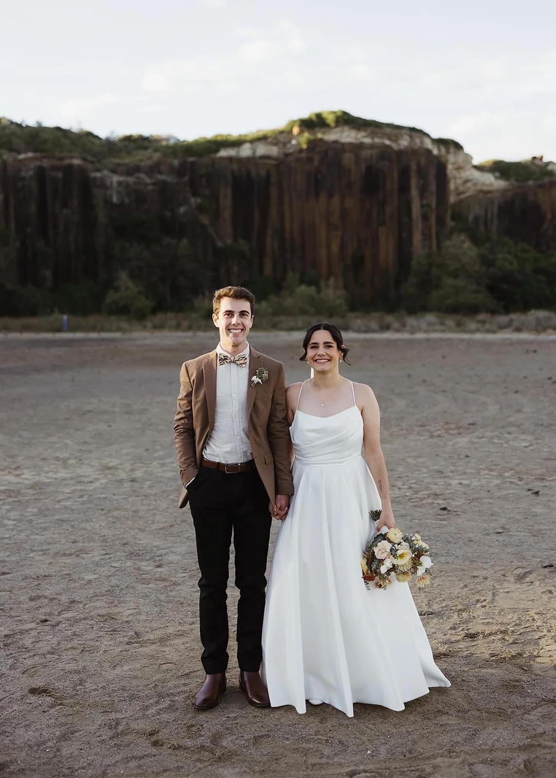 Rustic and natural winter wedding in the Illawarra with native and whimsical cottage flowers. The couple celebrated with a ceremony at Figtree Anglican Church, scenic views at Cathedral Rocks, and reception at Ruby’s Mt. Kembla, combining seasonal bl
