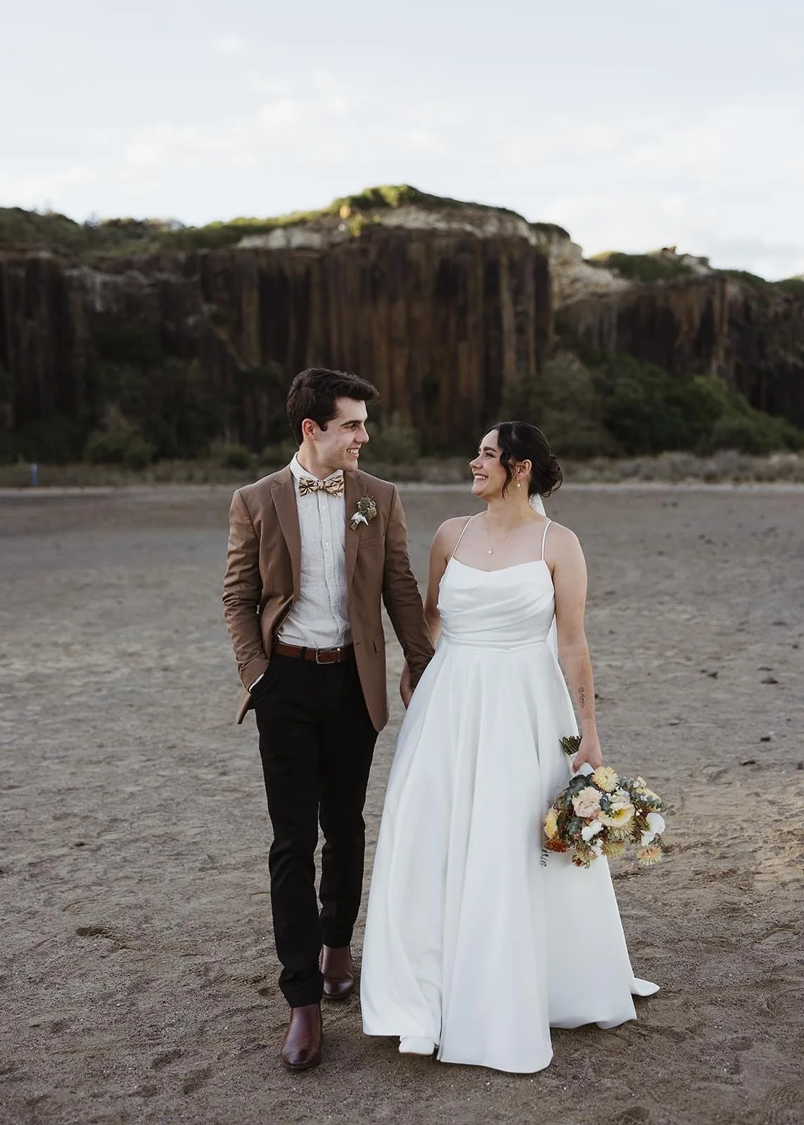 Rustic and natural winter wedding in the Illawarra with native and whimsical cottage flowers. The couple celebrated with a ceremony at Figtree Anglican Church, scenic views at Cathedral Rocks, and reception at Ruby’s Mt. Kembla, combining seasonal bl