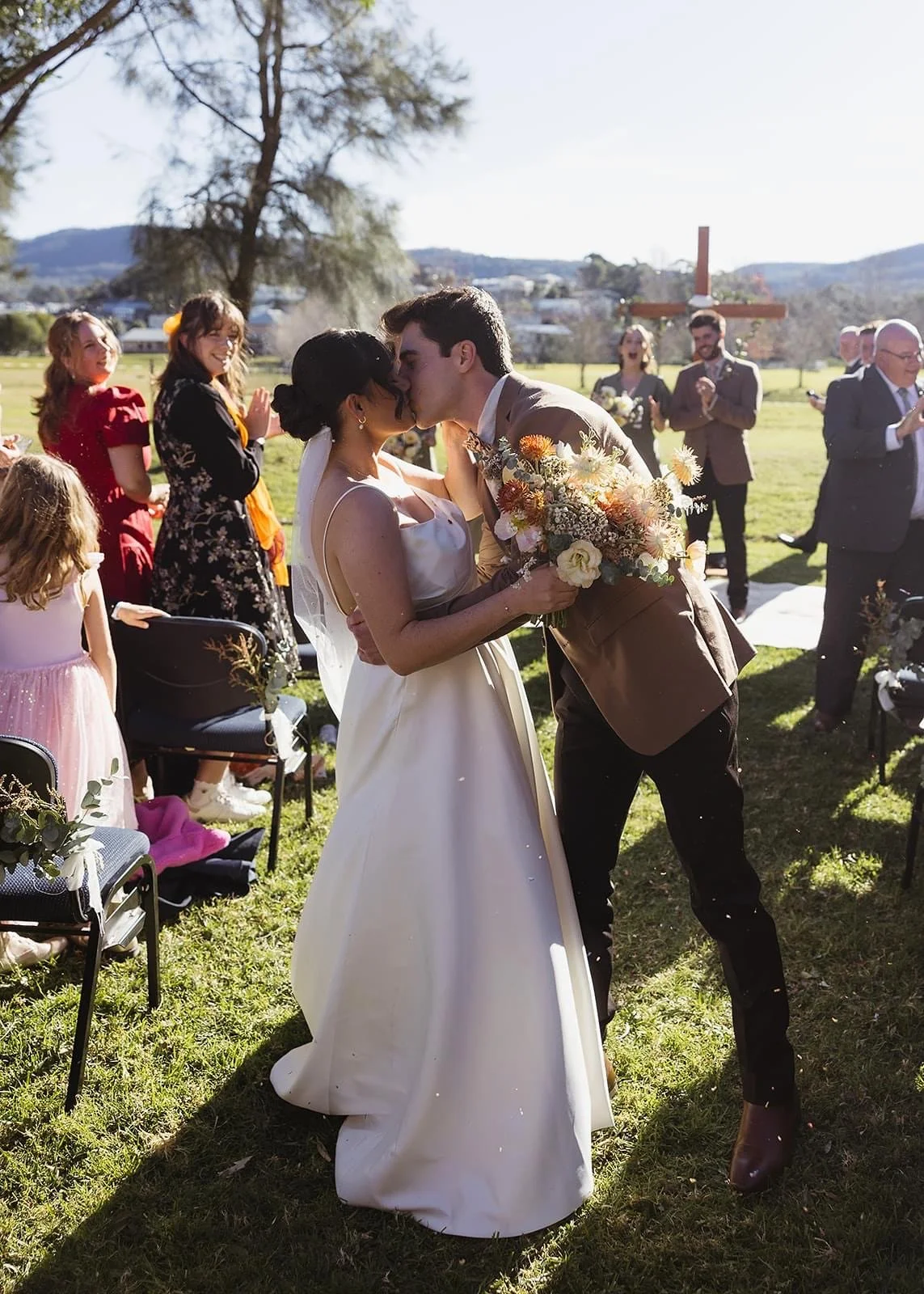 Rustic and natural winter wedding in the Illawarra with native and whimsical cottage flowers. The couple celebrated with a ceremony at Figtree Anglican Church, scenic views at Cathedral Rocks, and a reception at Ruby’s Mt. Kembla, combining seasonal 