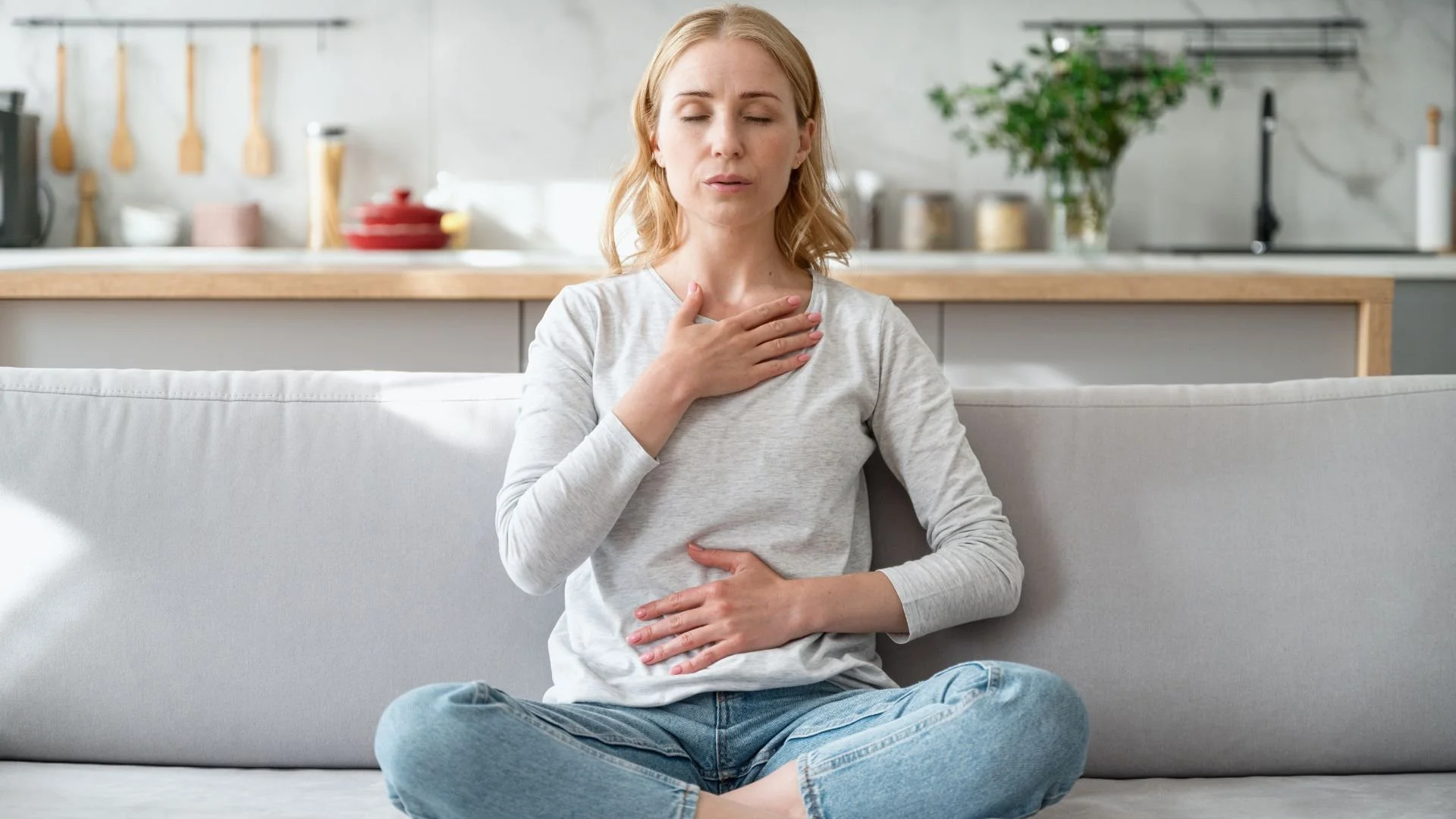 A woman practicing calming breathing exercises with her eyes closed, focusing on mindfulness and recovery after experiencing a panic attack, demonstrating coping strategies.