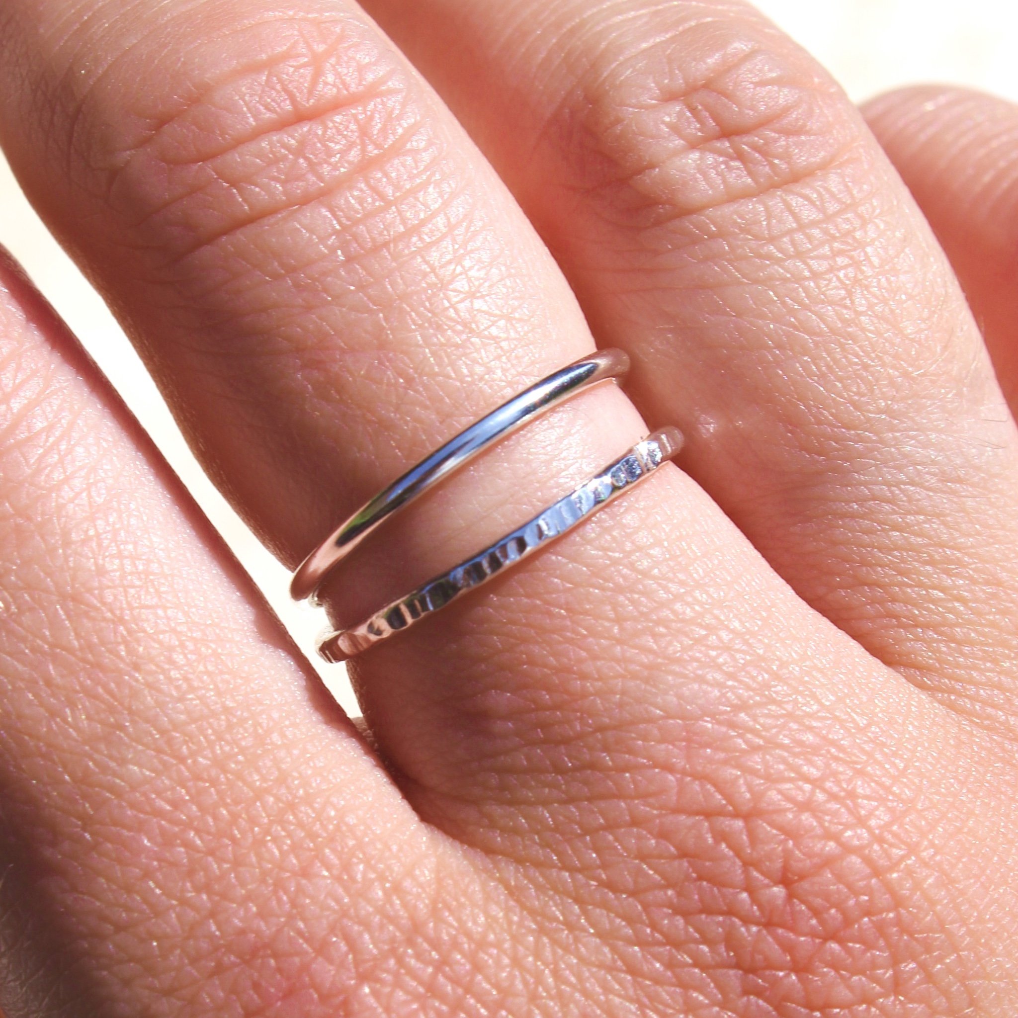 silver-stacking-ring-plain-and-textured-separated-on-finger.jpg