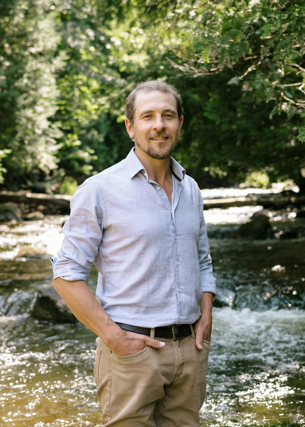 Joel Loughead standing in the Beaver River in Kimberly, Ontario.