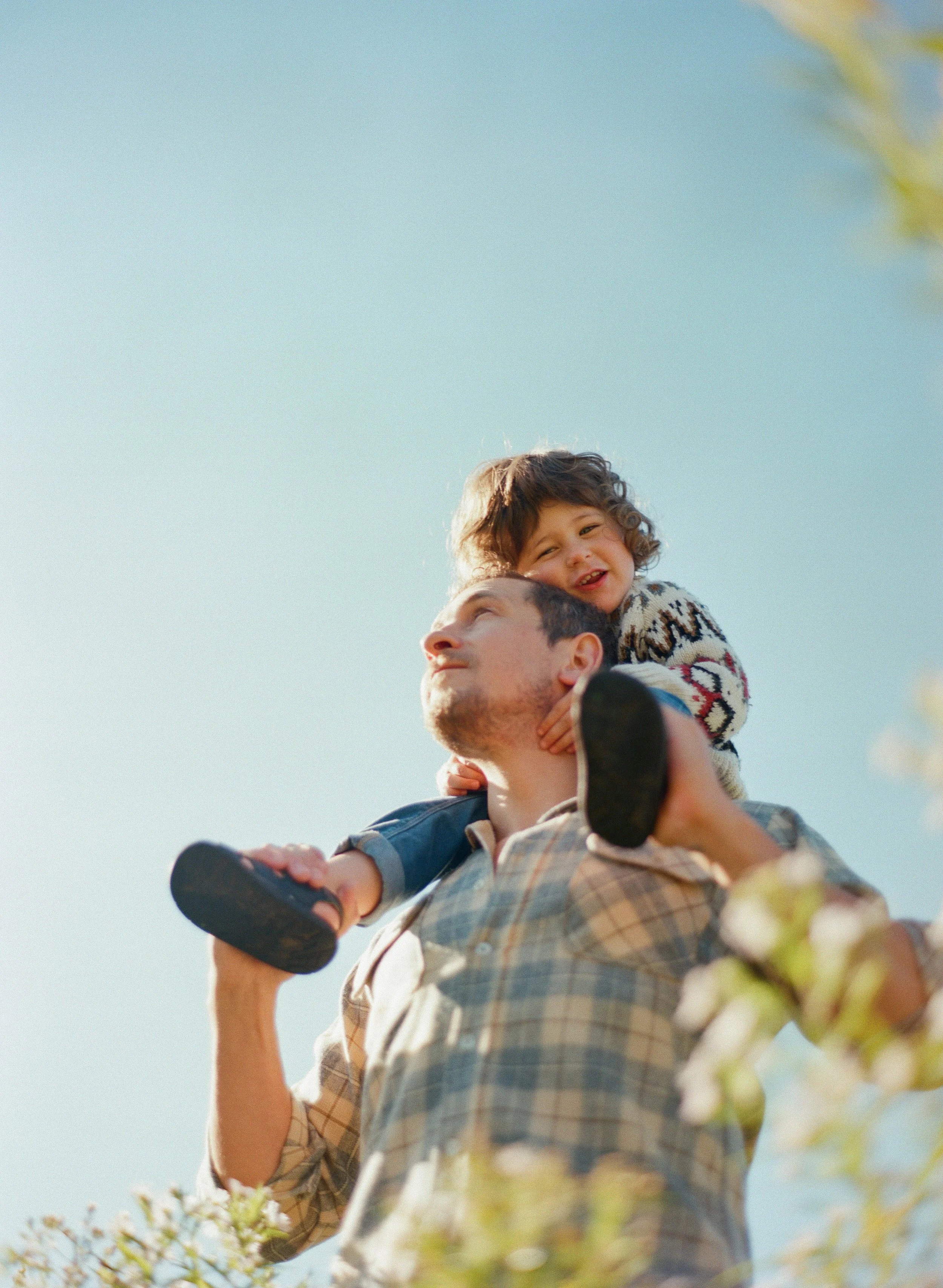 Joel Loughead carrying his son on his shoulders in Kimberley, Ontario